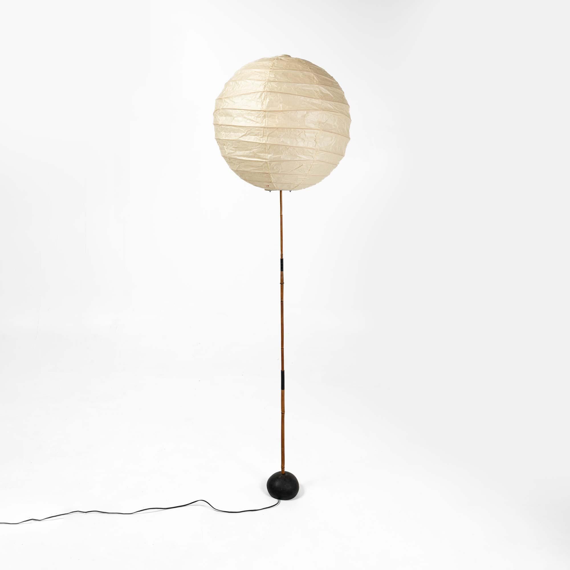 An iconic and early vintage Isamu Noguchi Akari floor lamp, 55d shade on bb3 base, made with Bamboo and enameled steel with a paper shade. 

The 55d paper shade was purchased but rarely used, still in original brown paper packaging. Overall, it is