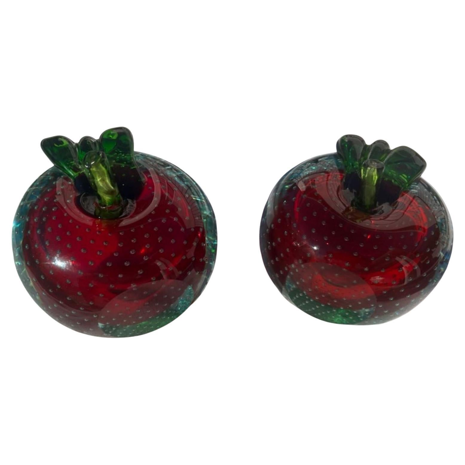 Pair of Italian Art Glass apples. Wonderful deep red transparent color with intentional bubbles on the surface of the apples. The green stem is a seperatly added piece completing each apple. 