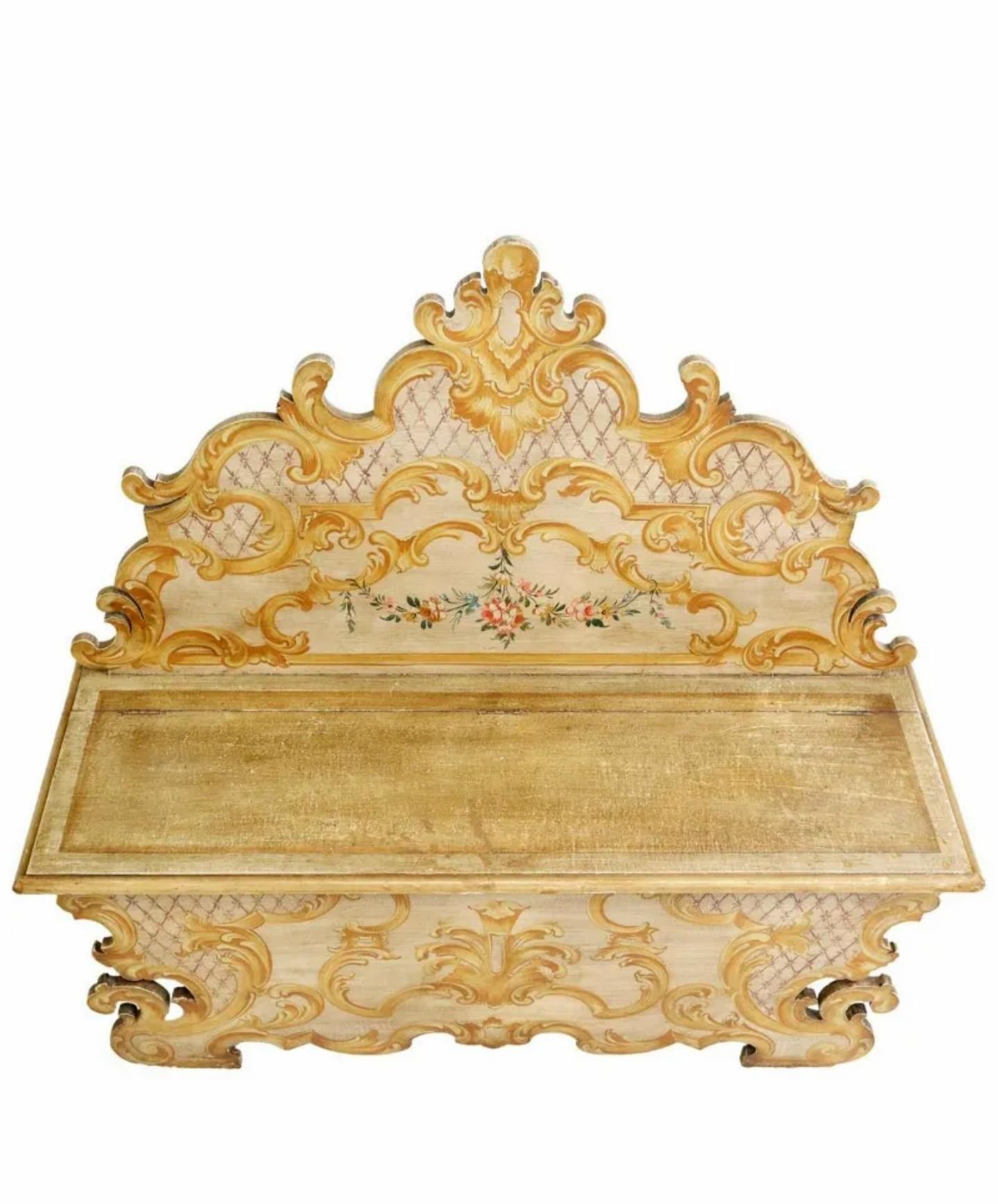A stunning antique Italian Baroque style hand-painted wooden hall bench.

Born in Italy in the early 20th century, hand-crafted solid wood construction, richly decorated sculptural silhouette, having a shaped back with scroll crest, hinged bench