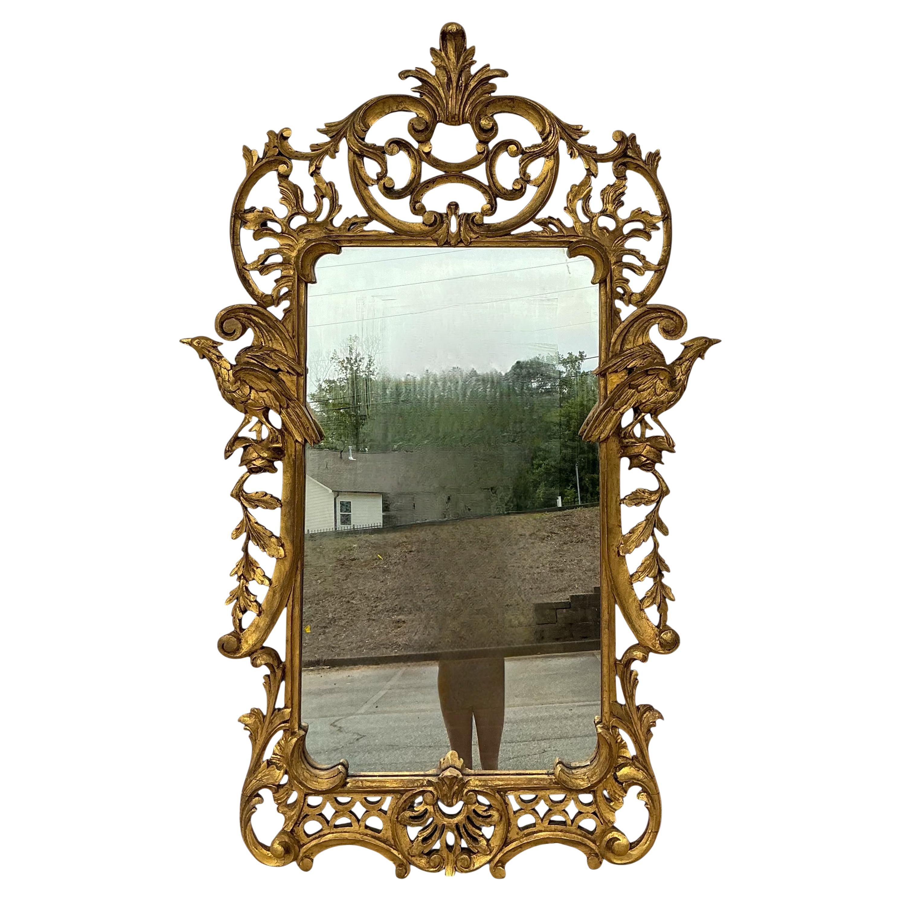 This is a wonderful early Italian carved giltwood mirror. It has carved Ho Ho birds flanking each size giving it majestic Chinese Chippendale styling. It is unmarked.