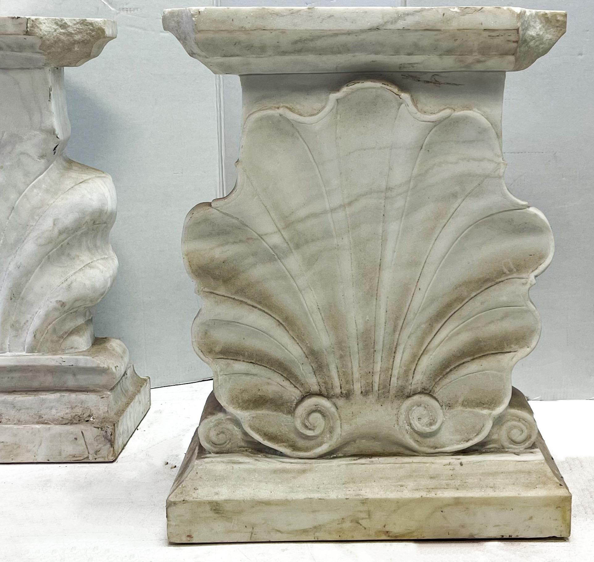 These area amazing! This offering is a pair of Italian carved marble shell form console tables. There is some notable chipping to the tops. They have classical styling that could make a statement for interiors or exteriors!