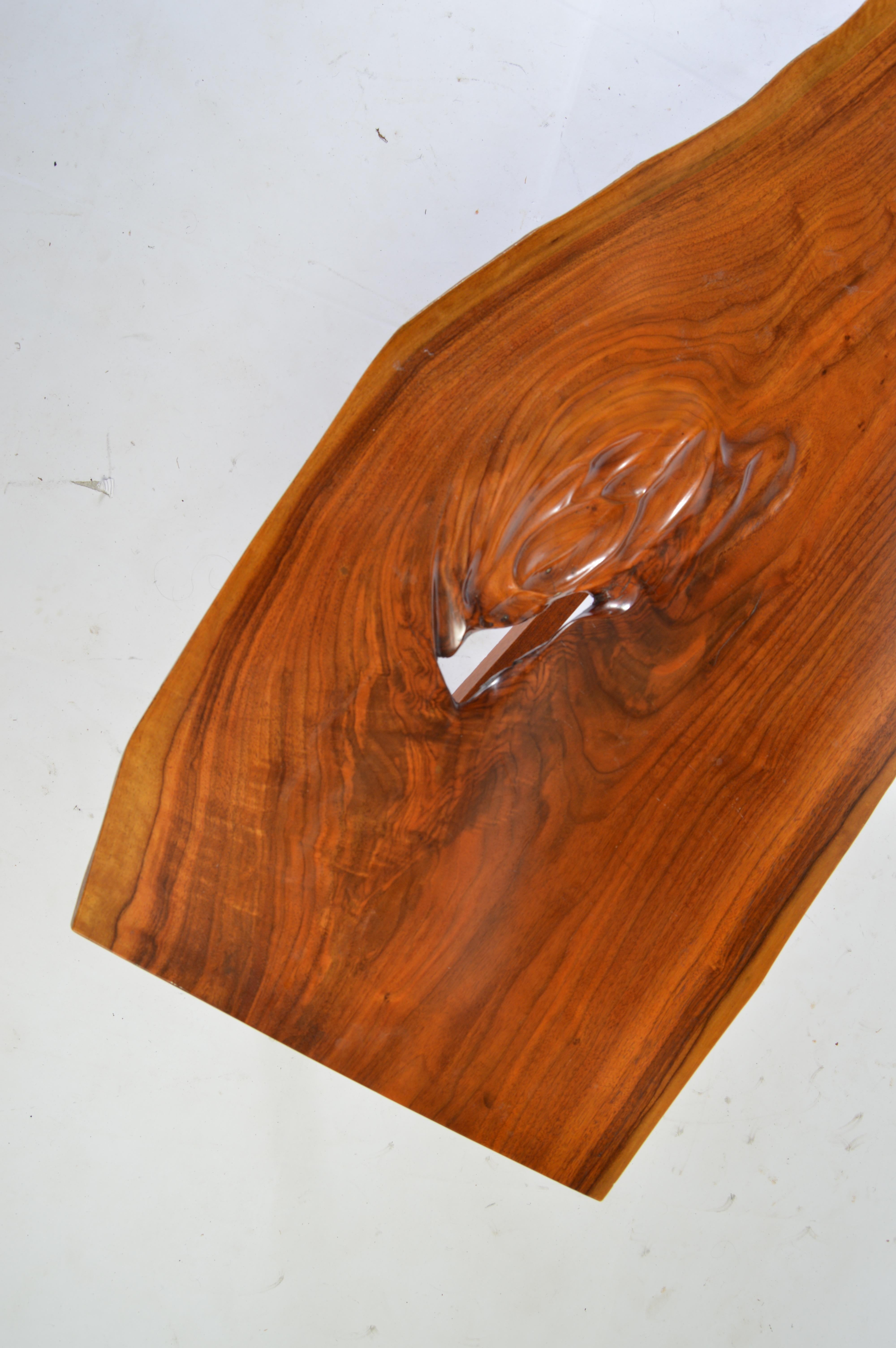 An early example of James Martin's work created while he was still working at The Nakashima Studio in New Hope, PA. 
 The walnut used is adjusted with notching by Jim Martin detailing his signature style. James Martin would later open his own