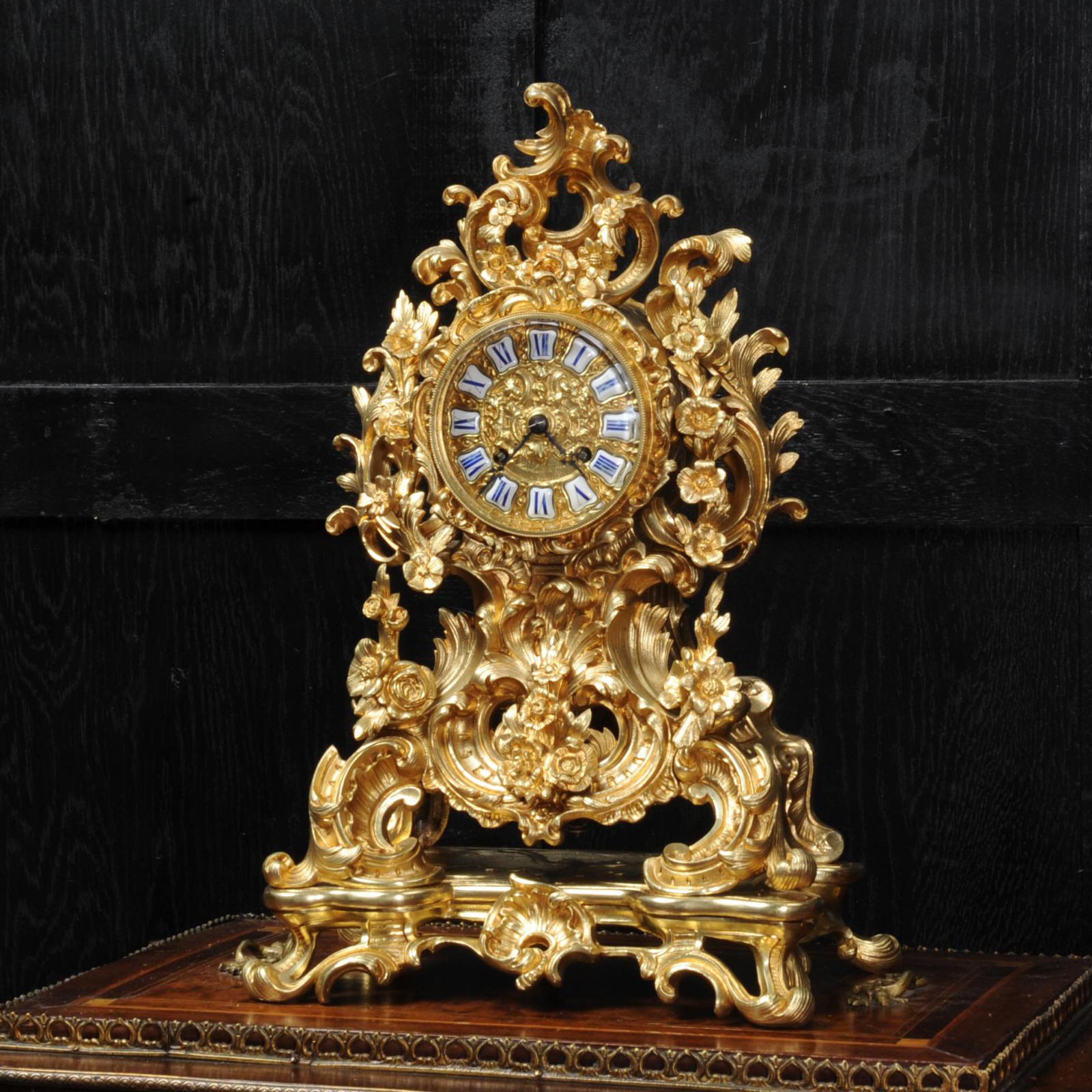 A stunning and early ormolu antique French clock by Japy Freres and retailed by Marshall et Fils of Paris. Dating from circa 1840, it is beautifully modelled in finely gilded bronze, waisted shape formed of scrolling leaves and decorated with