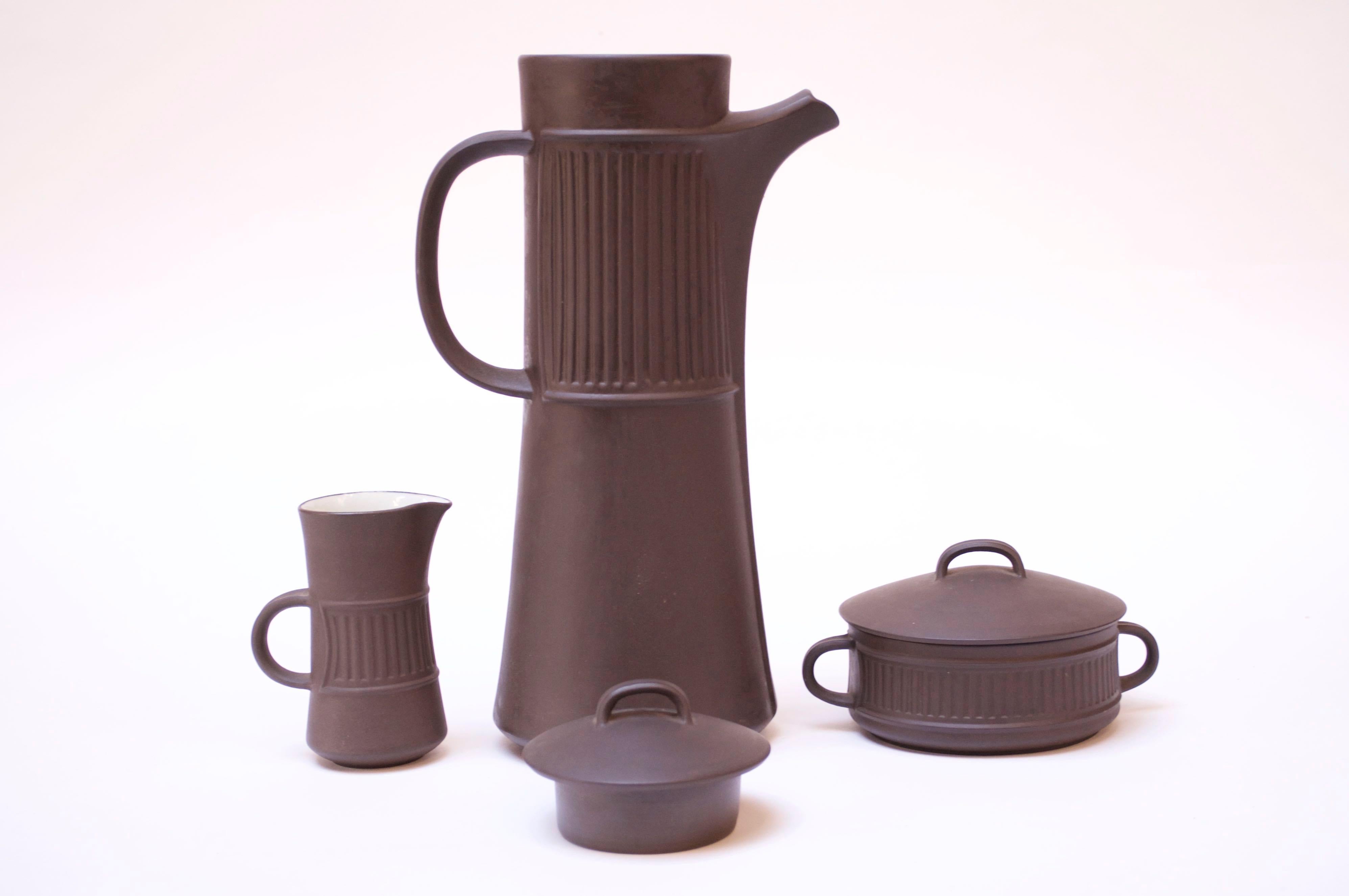 Denmark 'Flamestone' coffee or tea pot, creamer, and sugar by Jens H. Quistgaard for Dansk designs, circa 1958-1964 Features the Flamestone signature slate, almost brown glazed-earthenware with striated pattern and white porcelain interior. Elegant,
