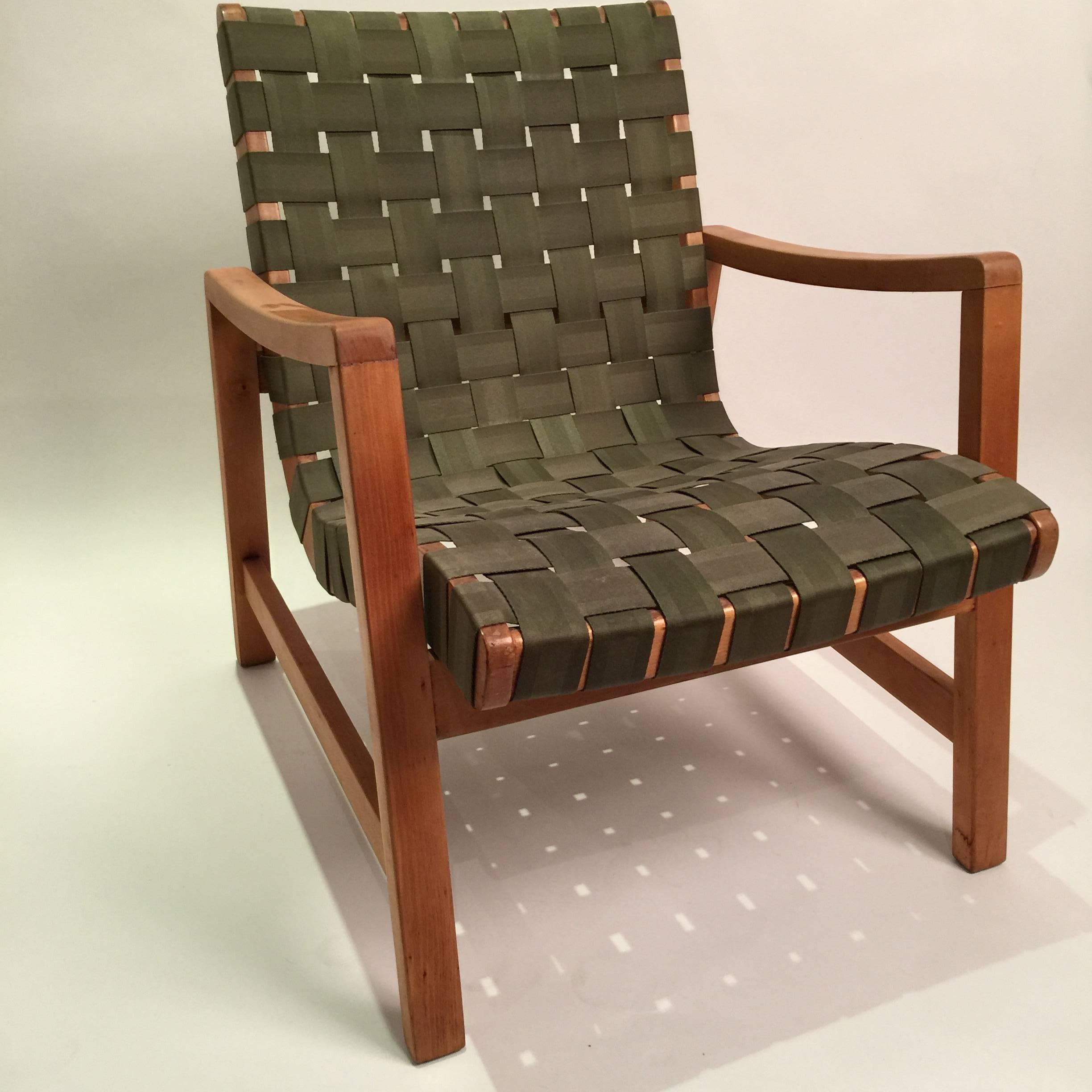 Early production of Jens Risom signature strap lounge chair. Bears heat transfer Knoll makers mark and original straps.
 