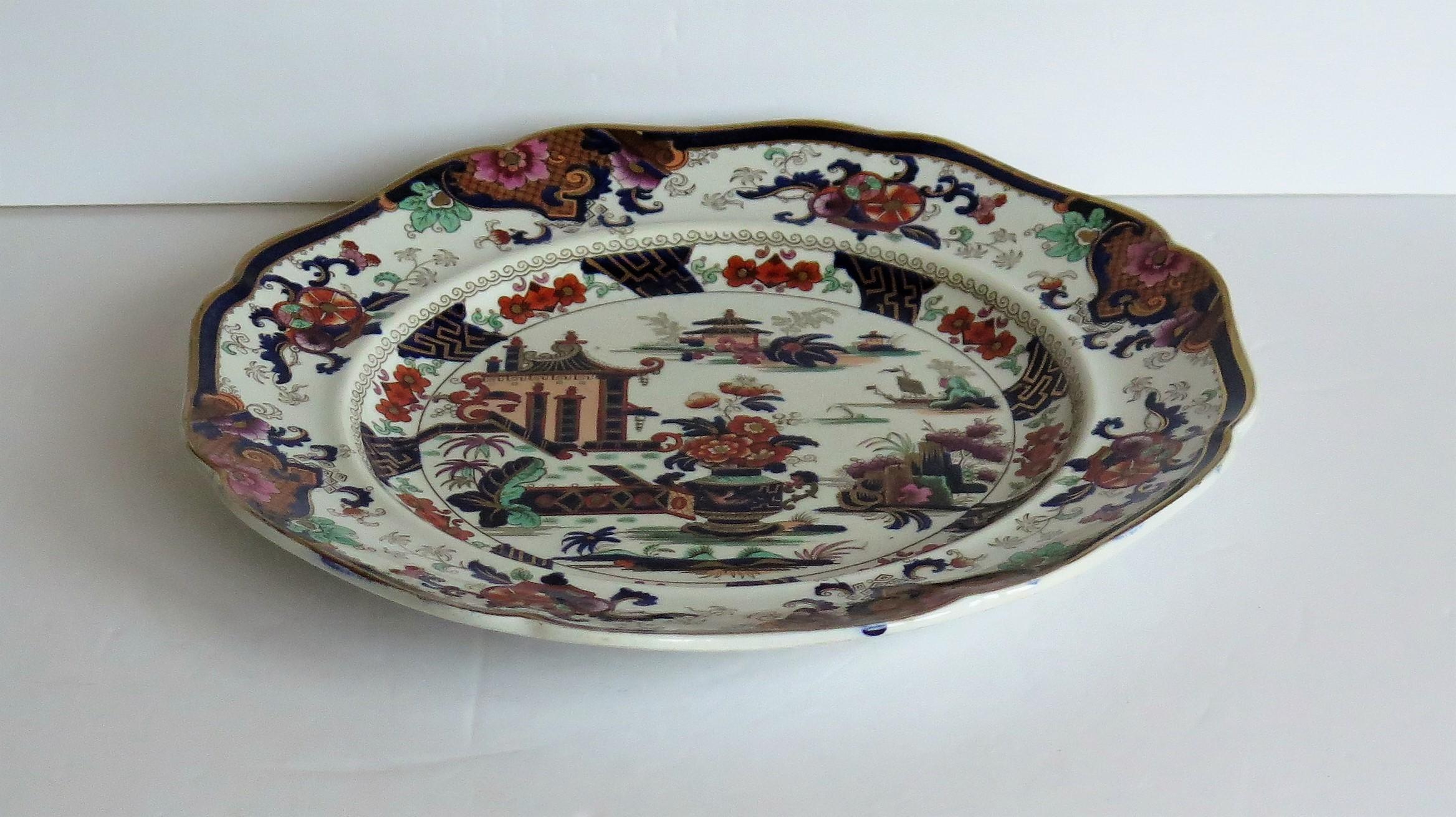This is a highly decorative, Superior Stone China (ironstone), large plate by John Ridgway, dating to the William IV period of the 19th century, circa 1835.

This plate has been carefully hand painted, over a printed outline, in bold colorful