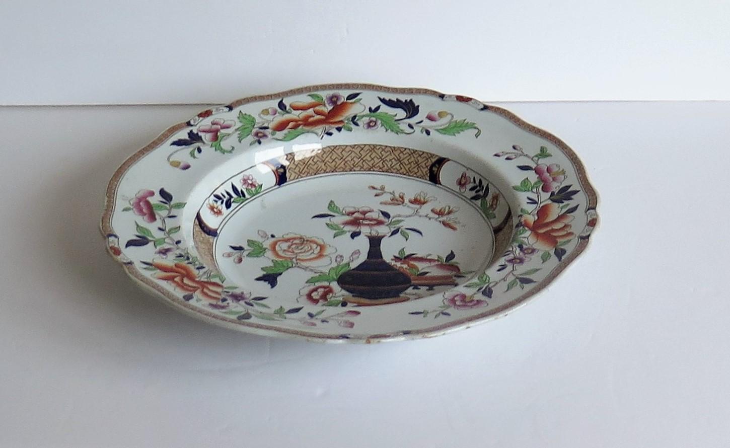 This is a very decorative, Imperial Stone China (ironstone), large deep plate or soup bowl by John Ridgway, dating to the William IV period of the 19th century, circa 1835.

This plate has been carefully hand painted, over a printed outline, in