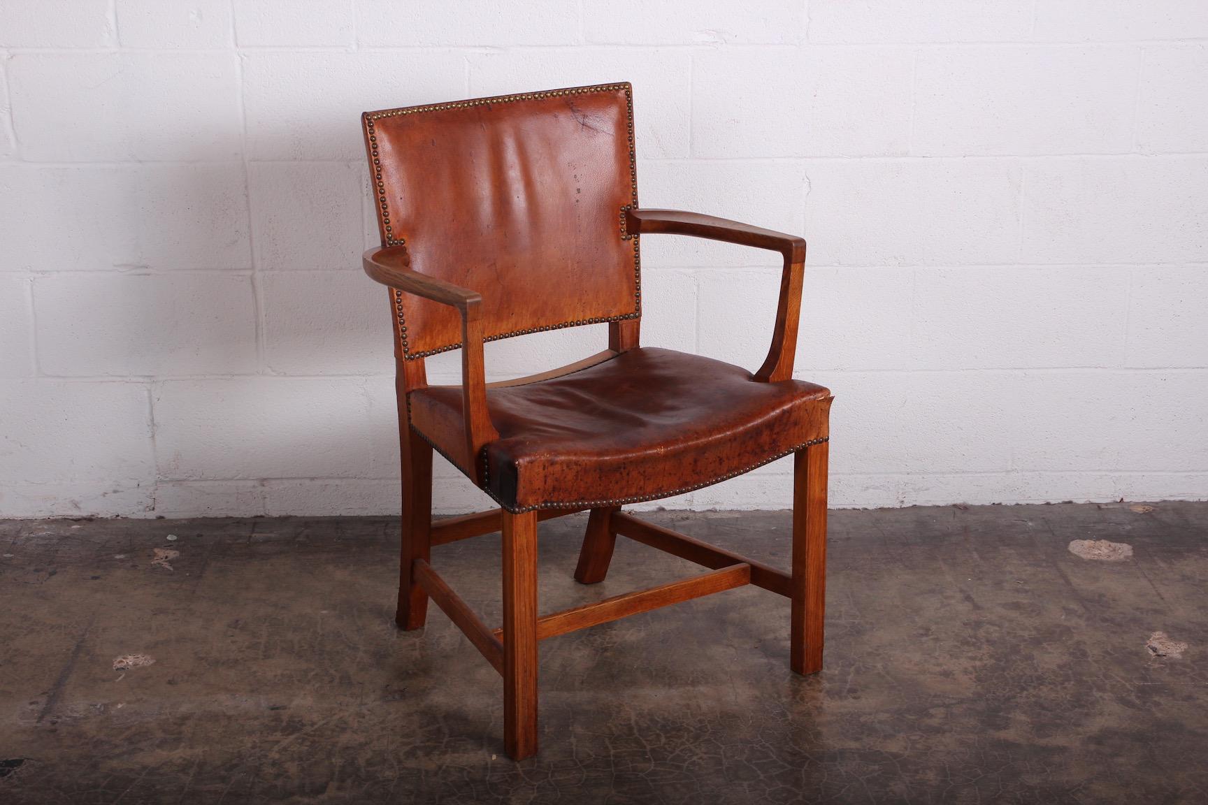 An early and rare all original example in oak and patinated Nigerian leather. Designed by Kaare Klint for Rud. Rasmussen, 1930s.