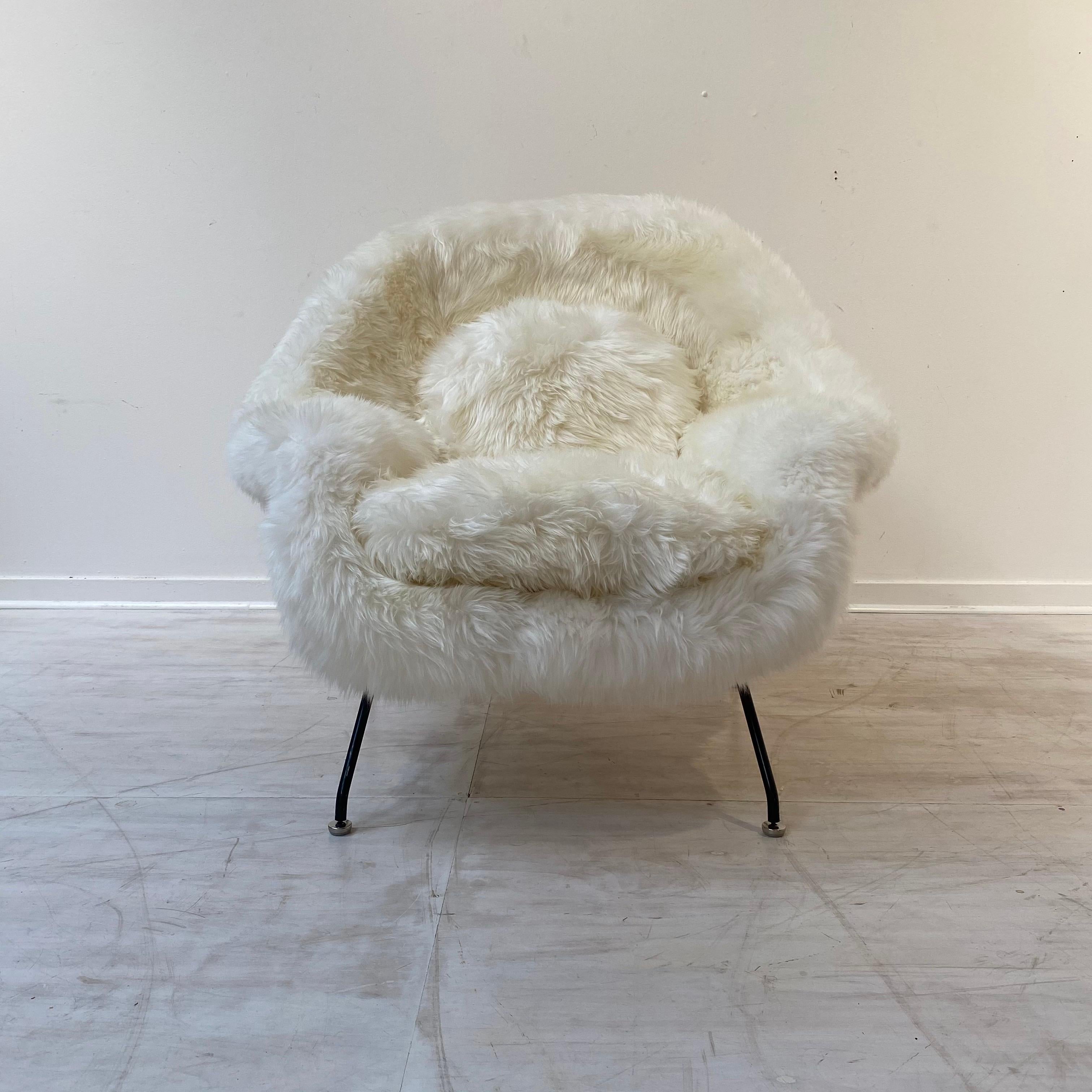 Outstanding and expertly restored womb chair by Eero Saarinen produced by Knoll. This piece has a stunning and luxurious natural sheepskin upholstery.
