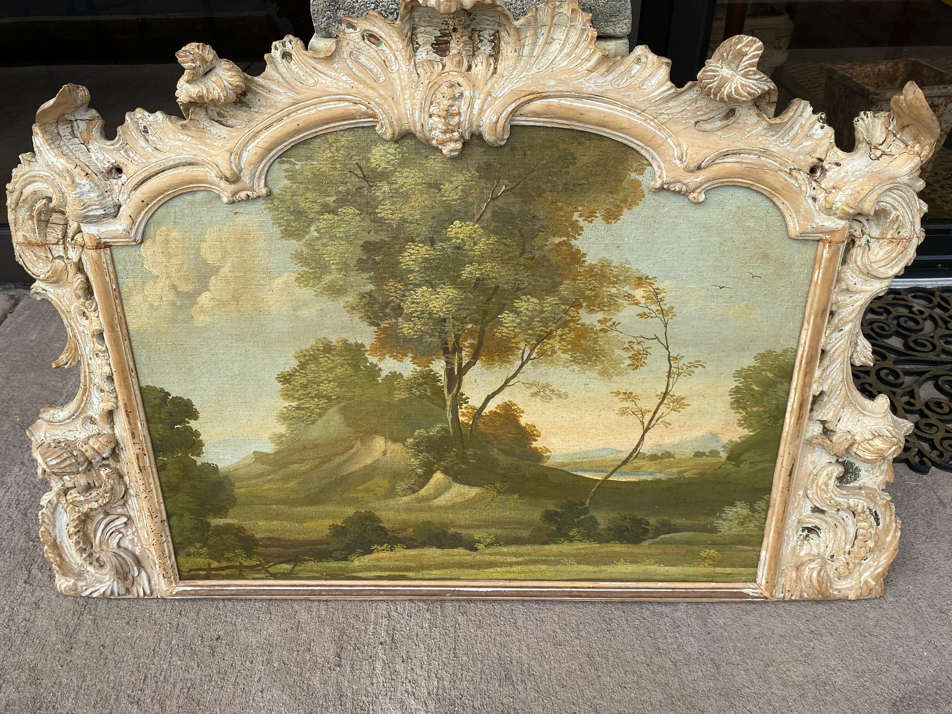 18th-19th century landscape, oil on canvas mounted on board with an exceptional carved and painted boiseries frame.