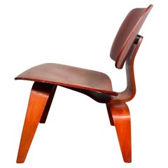 Early LCW Lounge Chair stained red by Charles and Ray Eames, Evans Plywood, 1950s