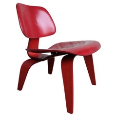 Early LCW Lounge Chair stained red by Charles & Ray Eames, Evans Plywood, 1950s