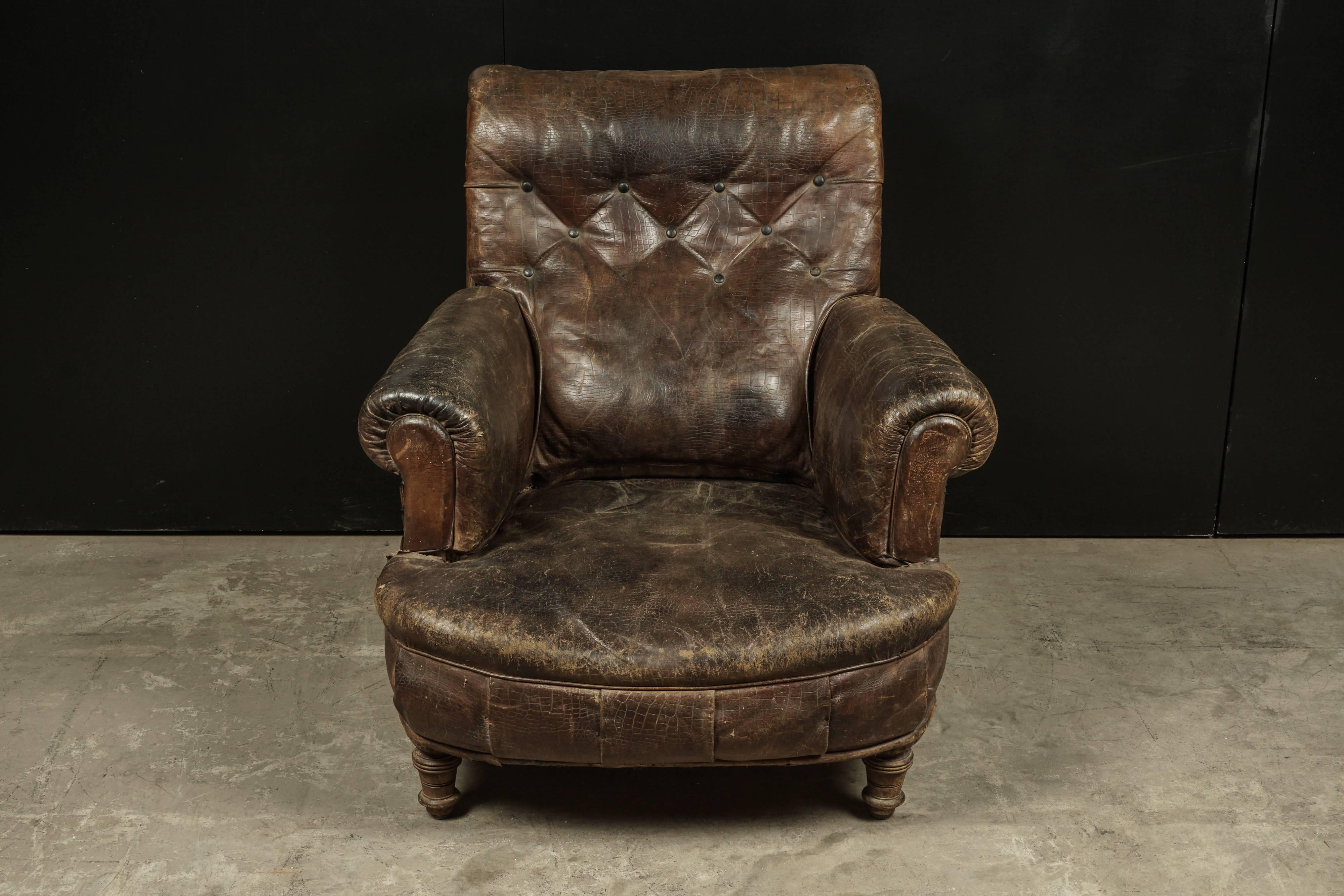 Early leather club chair from France, circa 1900. Superb patina with age related use and wear.