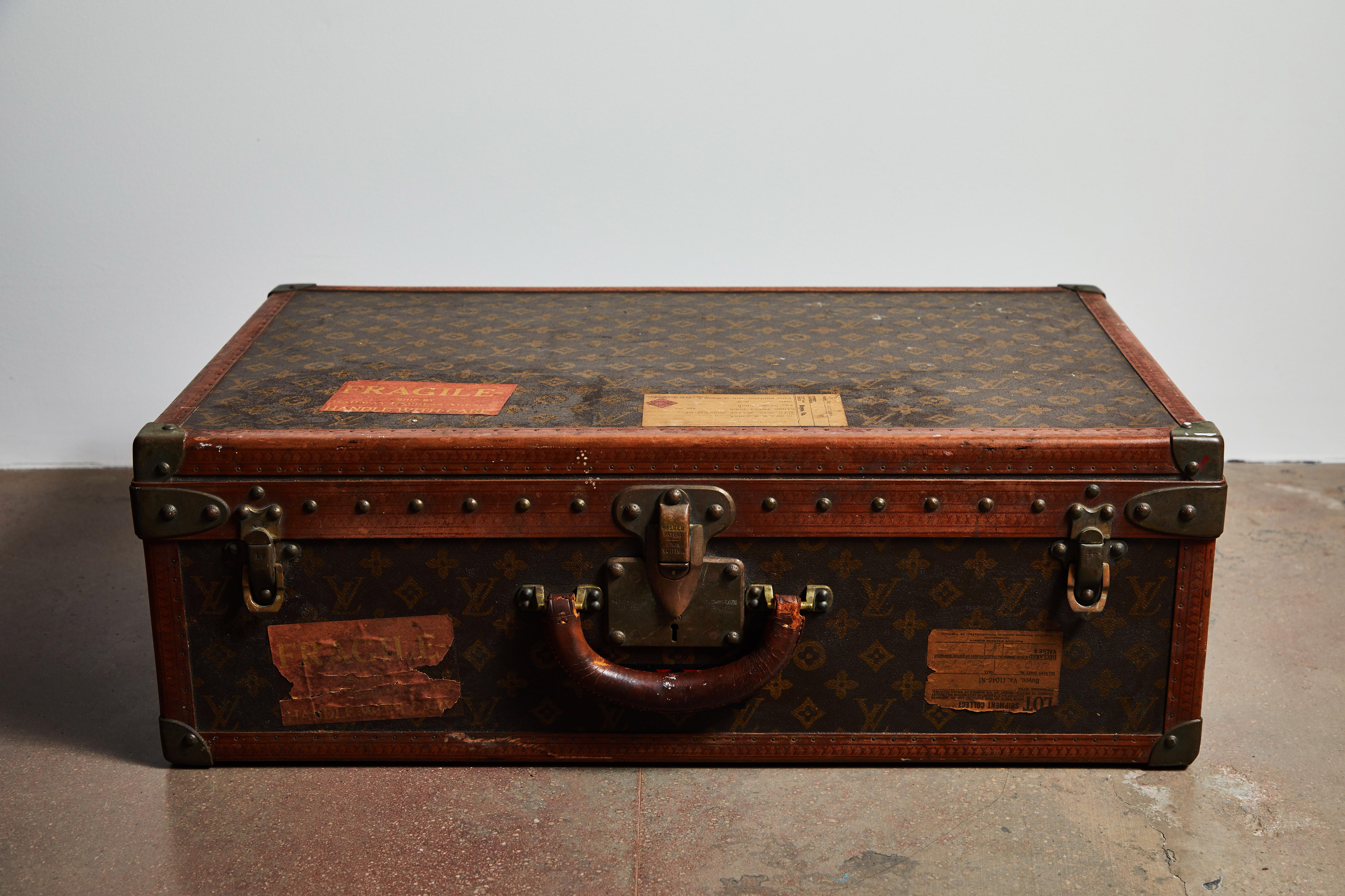 Early patinated Louis Vuitton hard case luggage or trunk. Has original travel stamps and initials of owner. Made in France, circa 1940s.