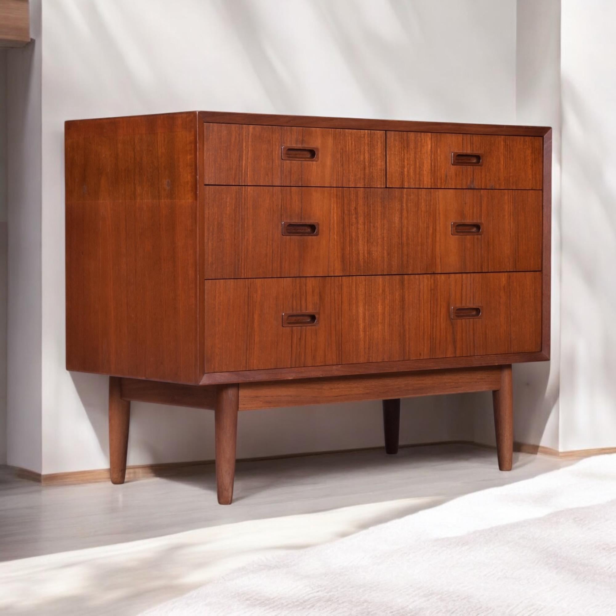 An exceptionally crafted Danish Modern teak chest of drawers by Lyby Mobler, Denmark, circa 1960s. This refined cabinet exemplifies the understated sophistication of mid-century Scandinavian design. The warm, luminous teak grain is accentuated by