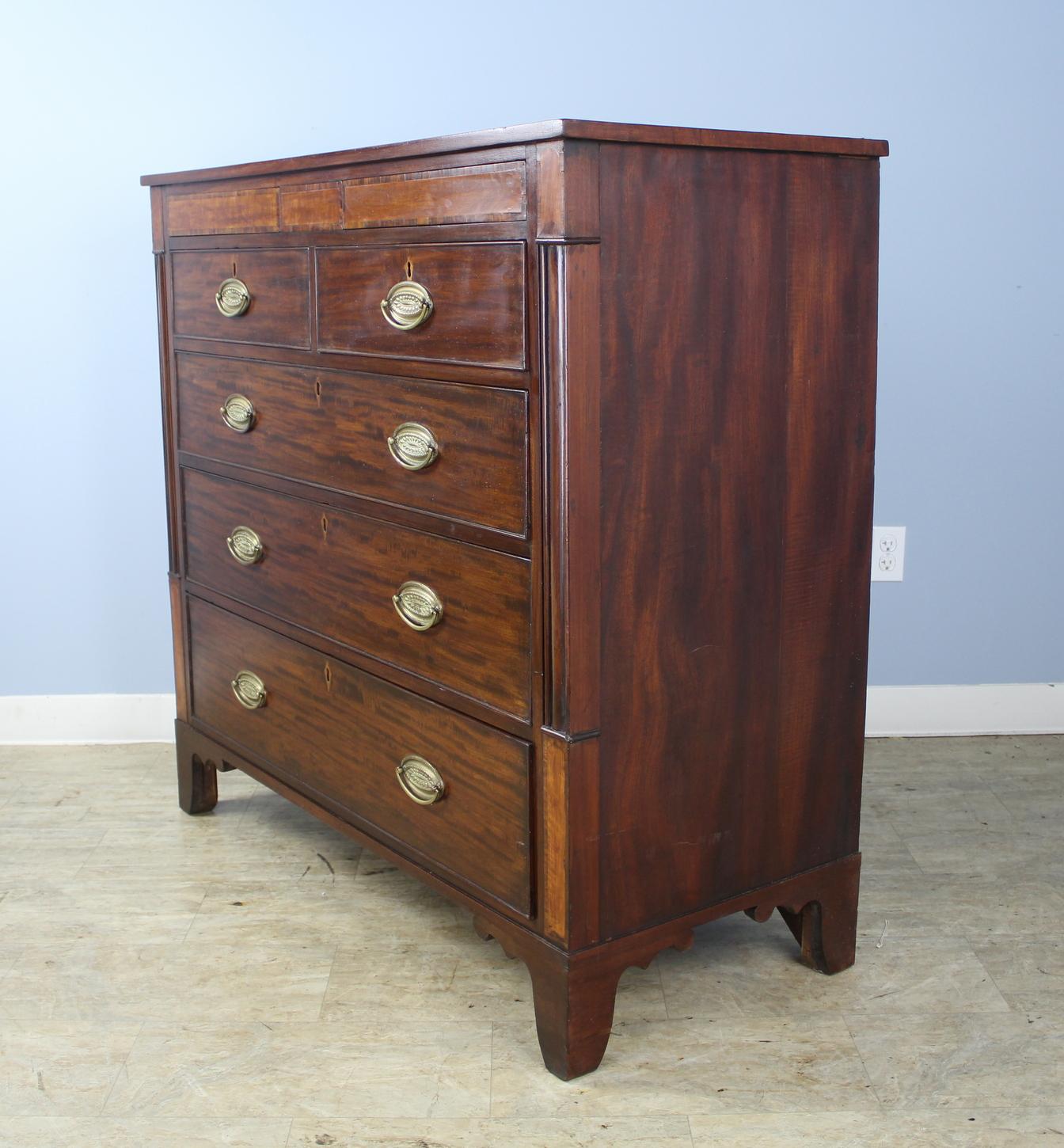 An early mahogany chest of drawers with lots of good period details. The top has a wide decorative band of ebony stringing, and there is an abundance of satinwood inlay around the drawers and keyholes. The drawers also have lovely intact cock