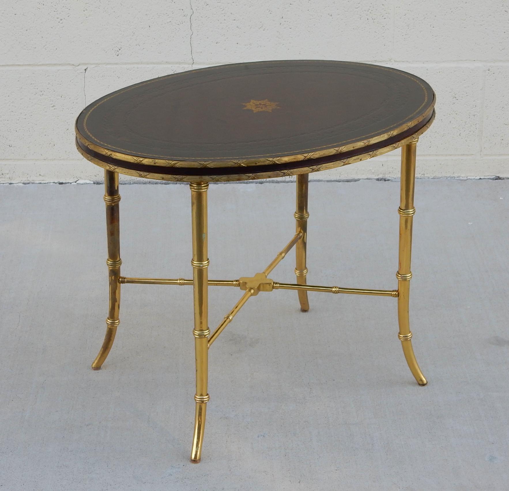 Fabulous occasional table by Maitland-Smith circa 1980.
Brown leather with banded trim.
Base is brass faux bamboo legs with cross supports.
Tagged, signed on bottom, Maitland-Smith.