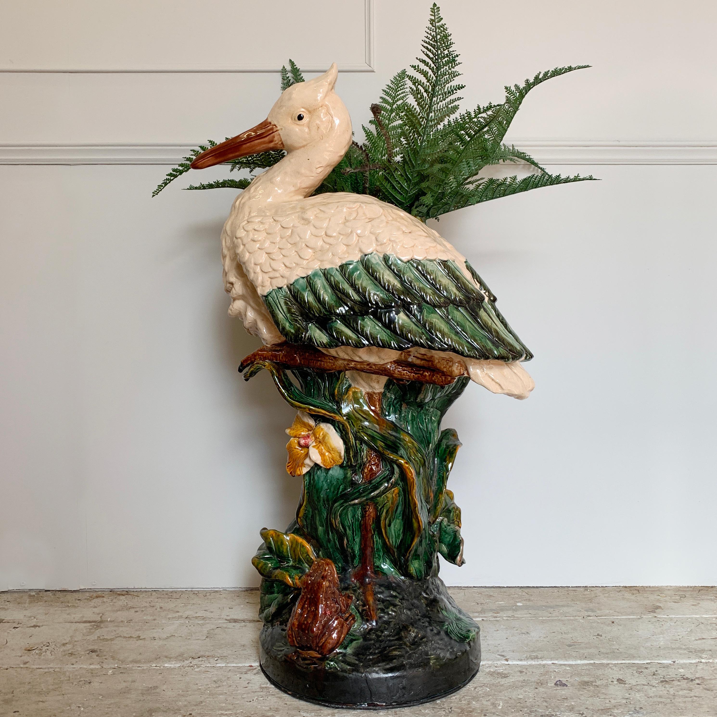 Early 20th century, Majolica stork umbrella stand/jardinière, Joseph Holdcroft/Minton style. This large impressive umbrella stand features a stork with leaf tendrils and flowers around the stem, a small frog sits looking up at the stork. 91cm