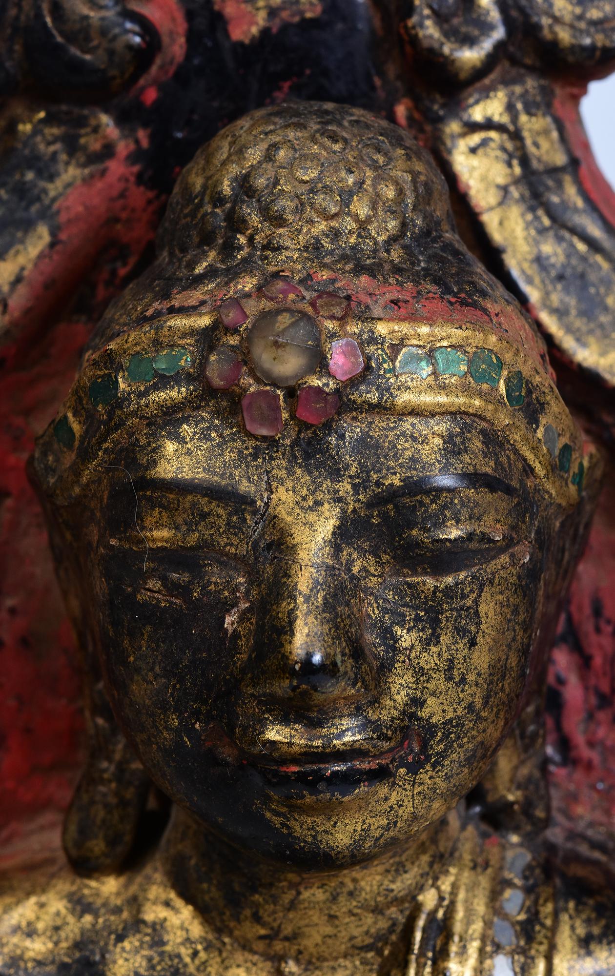 Antique Burmese lacquered seated Buddha on the throne, with gilded gold and glass.

Age: Burma, Early Mandalay Period, Early 19th Century
Size: Height 54 C.M. / Width 24.5 C.M. / Depth 20.3 C.M.
Condition: Nice condition overall (some expected
