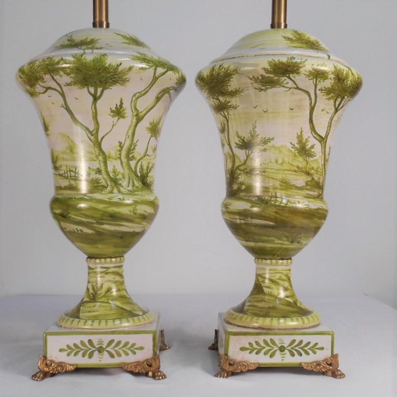 This early pair of Marbro urn table lamps feature beautiful Roman ruins, trees, plants and grasses. The urns are most likely Italian. They retain their original mogul base sockets (E39 lamp base) and electrical cord. Both have been inspected and are