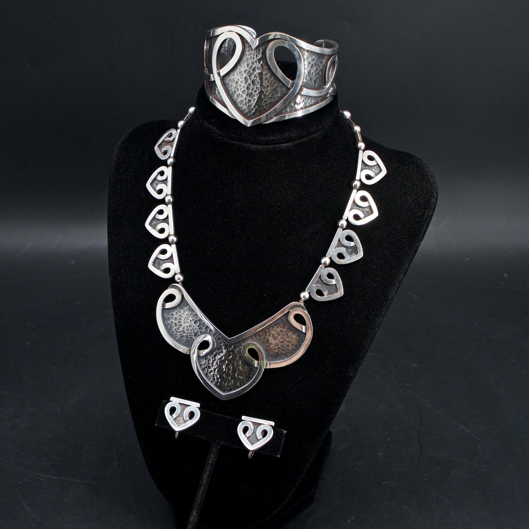 Margot Van Voorhies Carr started producing out of her own studio in 1948, under the name, Margot de Taxco. Previously she had been producing pieces under Antonio Castillo for the William Spratling studio. This four piece sterling silver suite is