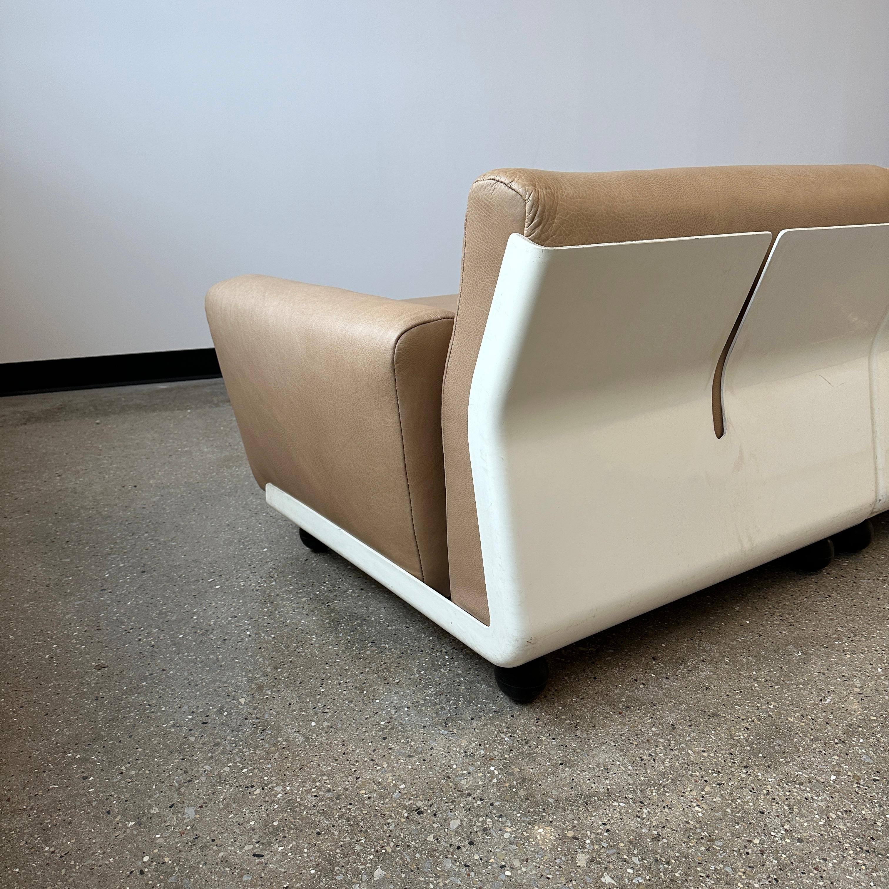 by C&B Italia c. 1968 and fully restored in leather. This piece has been signed + dated by the manufacturing team. The original maker’s insignia is also present on each piece. The fiberglass shells have some wear consistent with age and use on them,
