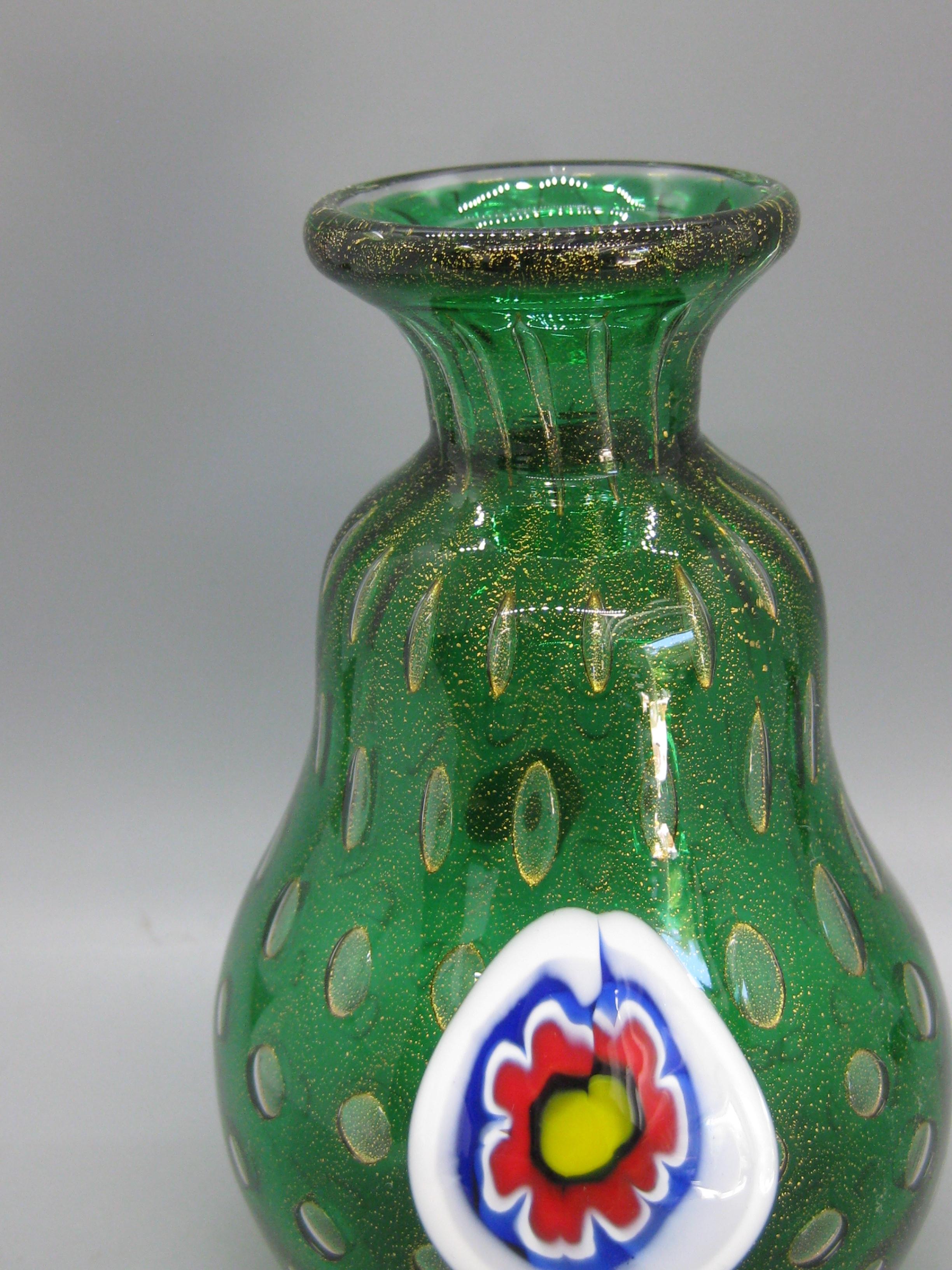 Wunderschöne Vase aus grünem Kunstglas, hergestellt von Mario Bambaro für Murano Glas, ca. 1960er Jahre. Goldflecken in der gesamten Vase. Hat ein Millefiori-Muster auf der Vorderseite. Hat das originale Folienetikett auf der Unterseite. Hergestellt