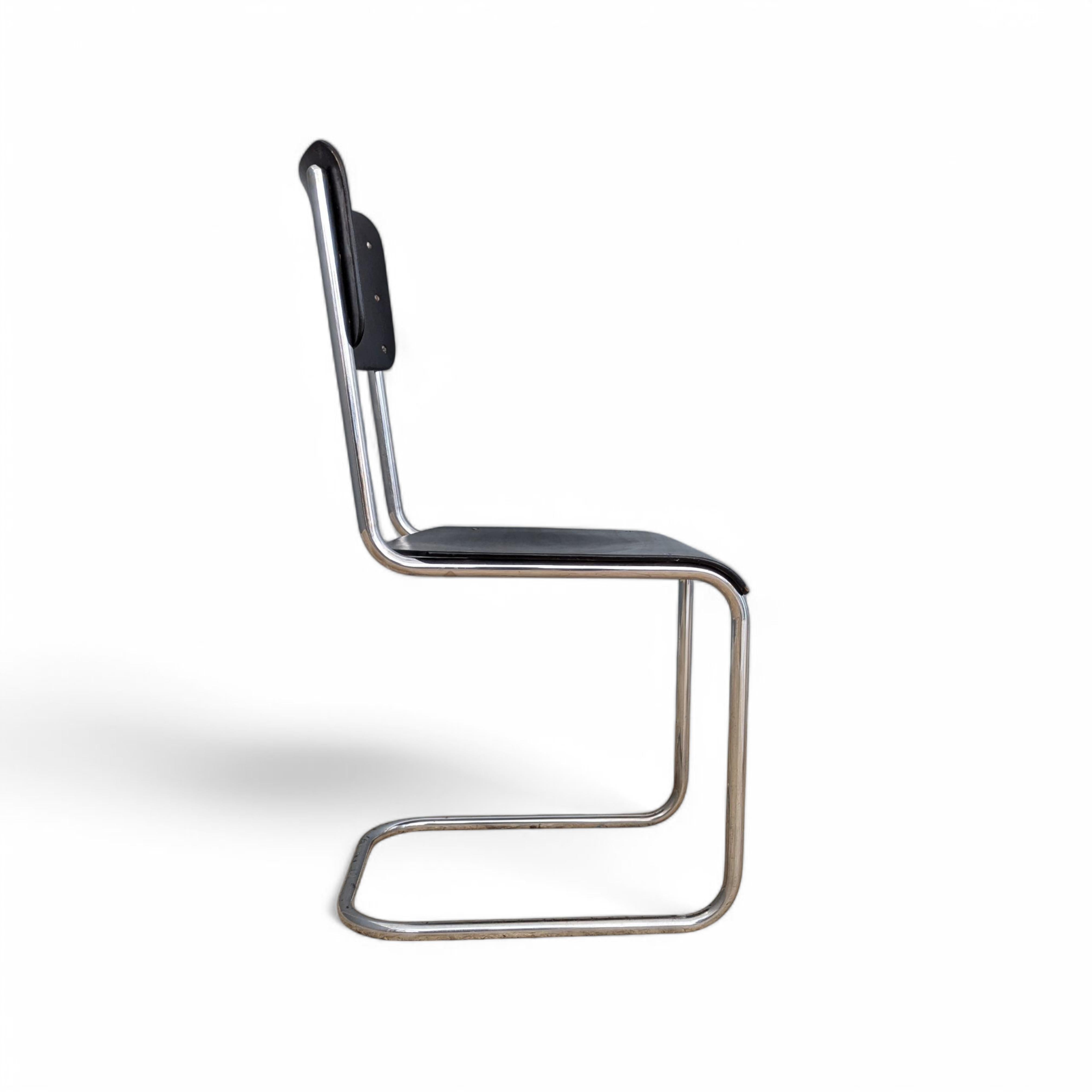 Early version manufactured by Vichr & co. , former Czechoslovakia in the 1930s. Made of black lacquered plywood and sturdy chrome plated tubular steel frame, showcasing vintage charm. The steel elements exhibit some minor signs of aging, while the