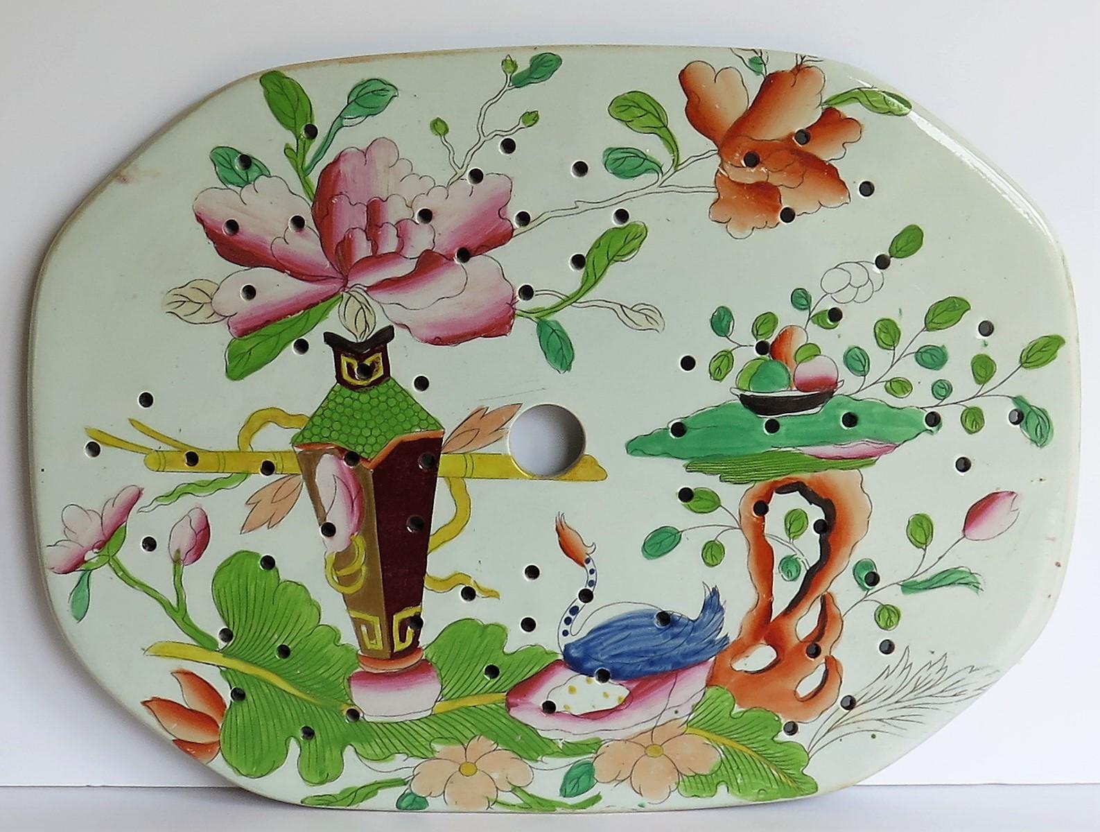 This is a large beautifully hand-painted Mason's ironstone drainer plate, in the table and flower pot pattern, from their earliest George IIIrd period, circa 1815. 

Mason's Ironstone drainers and strainers tend to be fairly rare.

This piece is in