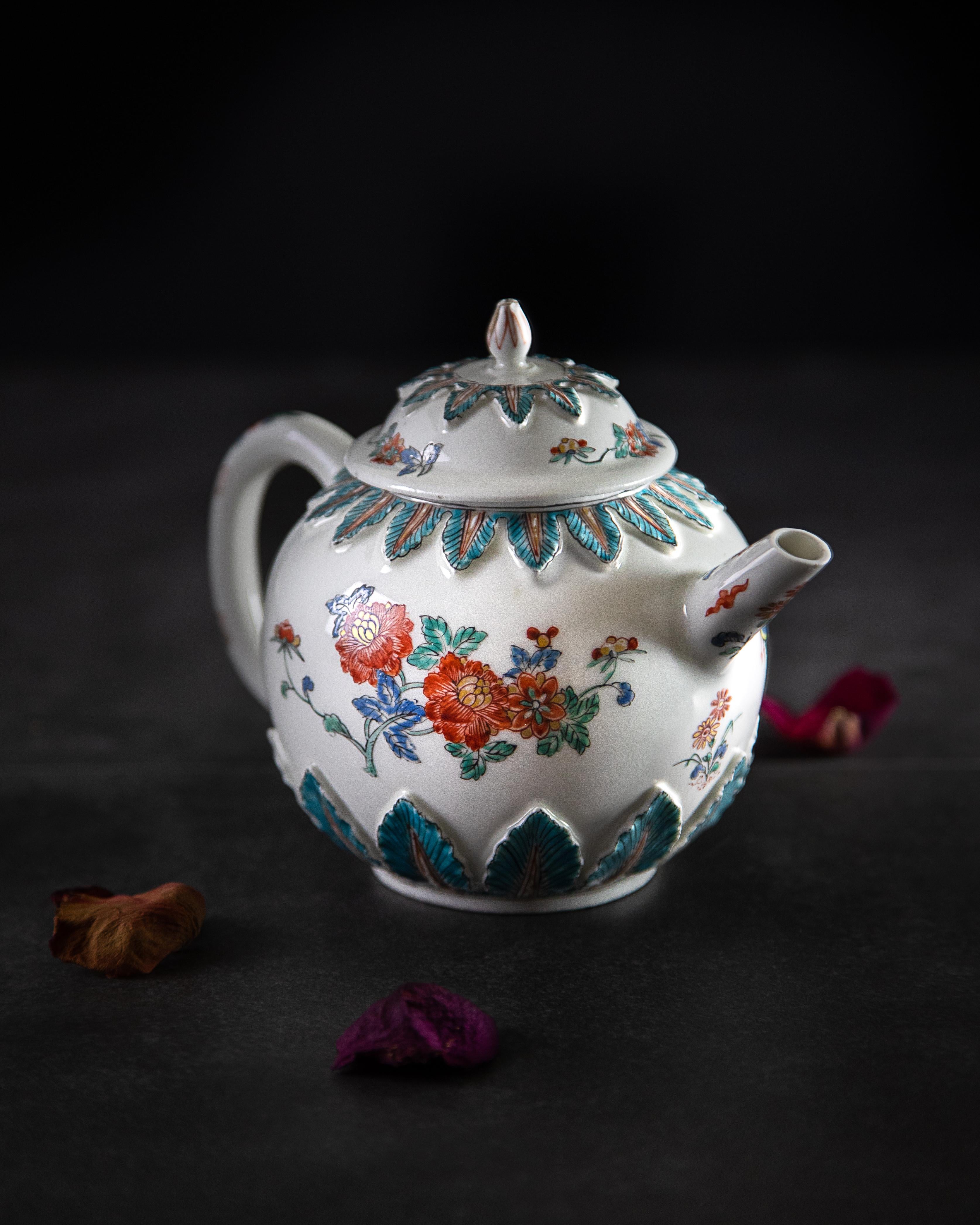 An early Meissen porcelain teapot made circa 1715, decorated by a Dutch hausmaler circa 1730-1740.

The teapot is decorated in a Kakiemon palette of turquoise, red, blue and yellow and enriched with gilding. The short, tapering spout and loop