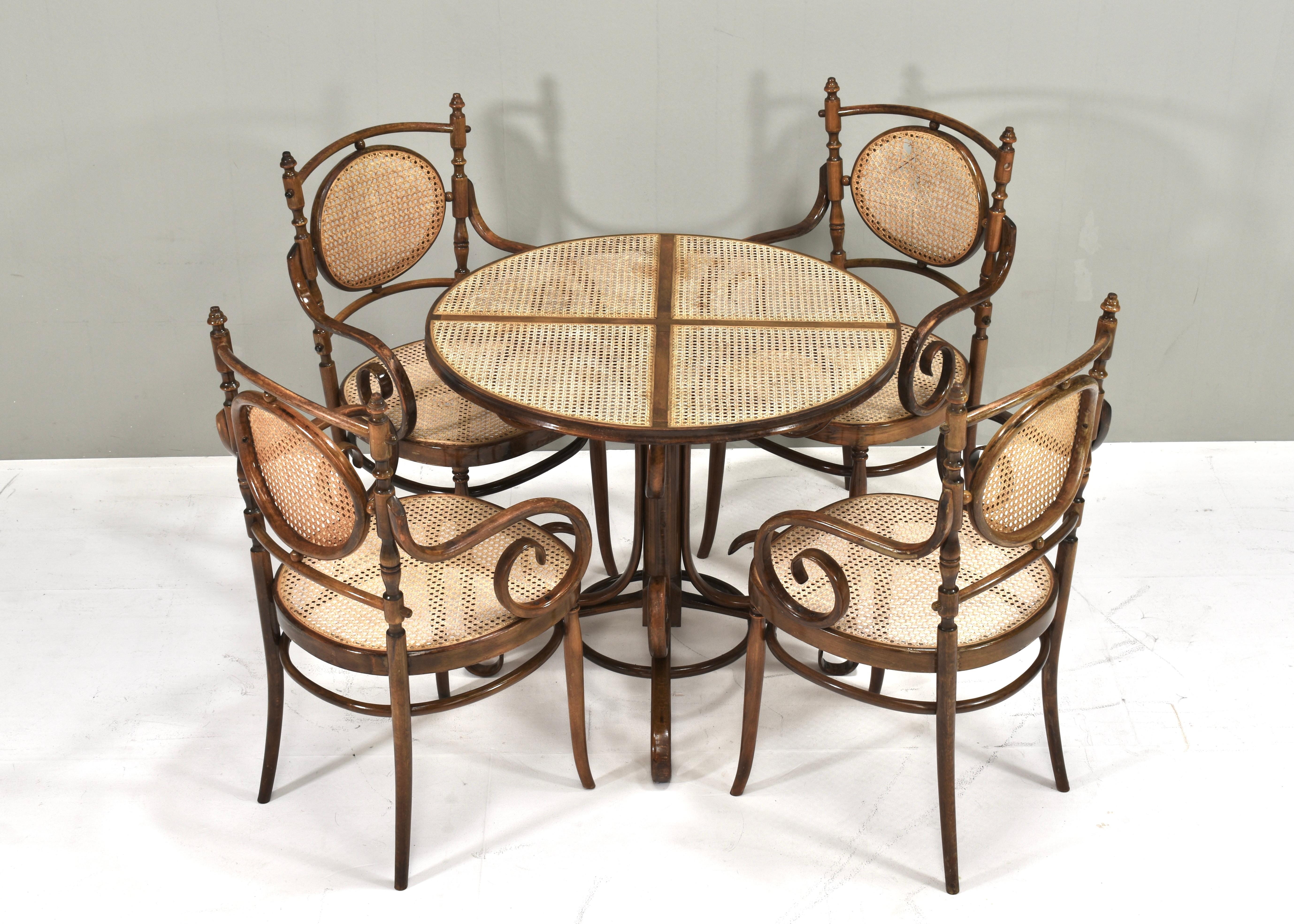 Bistro dining table in bentwood and cane designed by Michael Thonet. Originally designed in the 1860s and produced by Thonet in the 20th century by multiple factories.
Size:
chairs: 57x49x96.5 seat height 46 Arm height 67 centimeter
table: ø85.5
