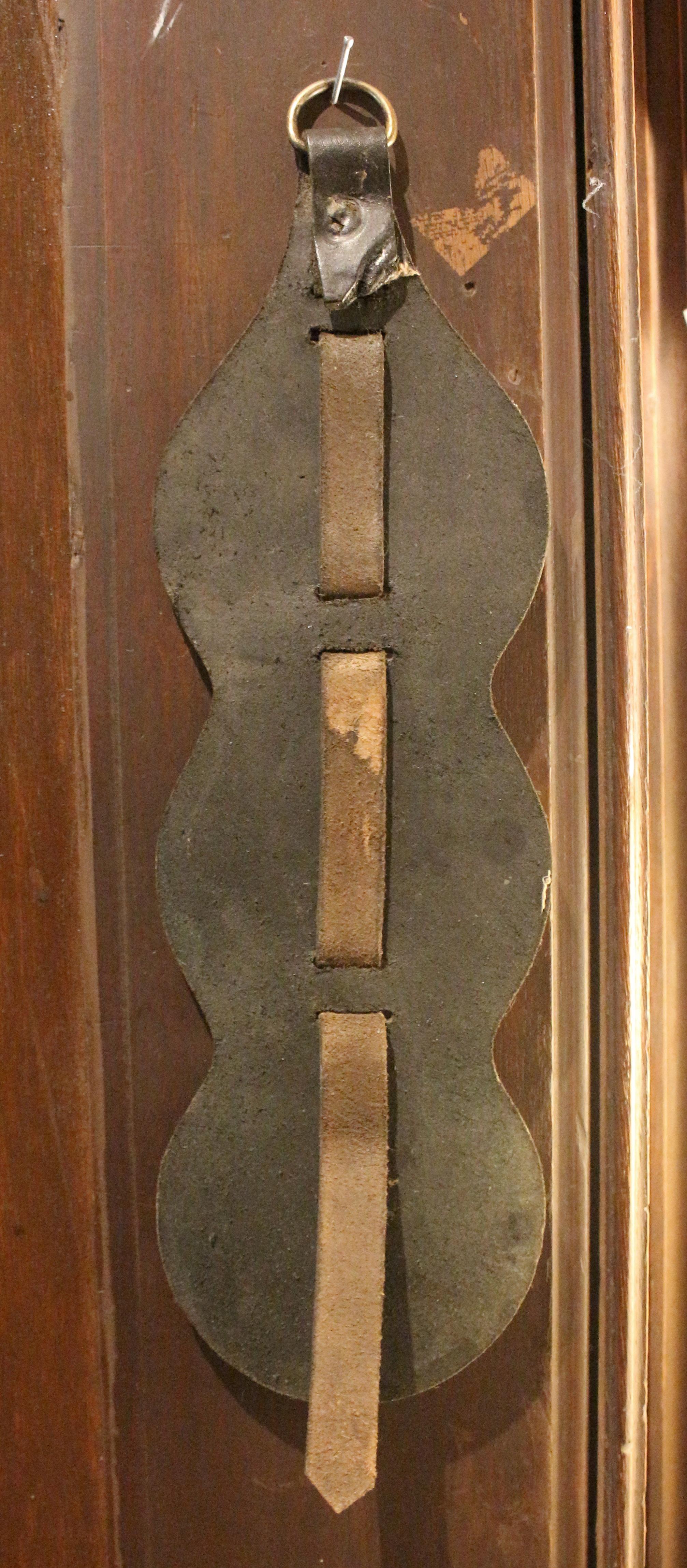 Early-mid 20th century English 3-brass leather horse strap. Shaped leather featuring brasses of a camel, pheasant, and the HMS Victory.
13.5