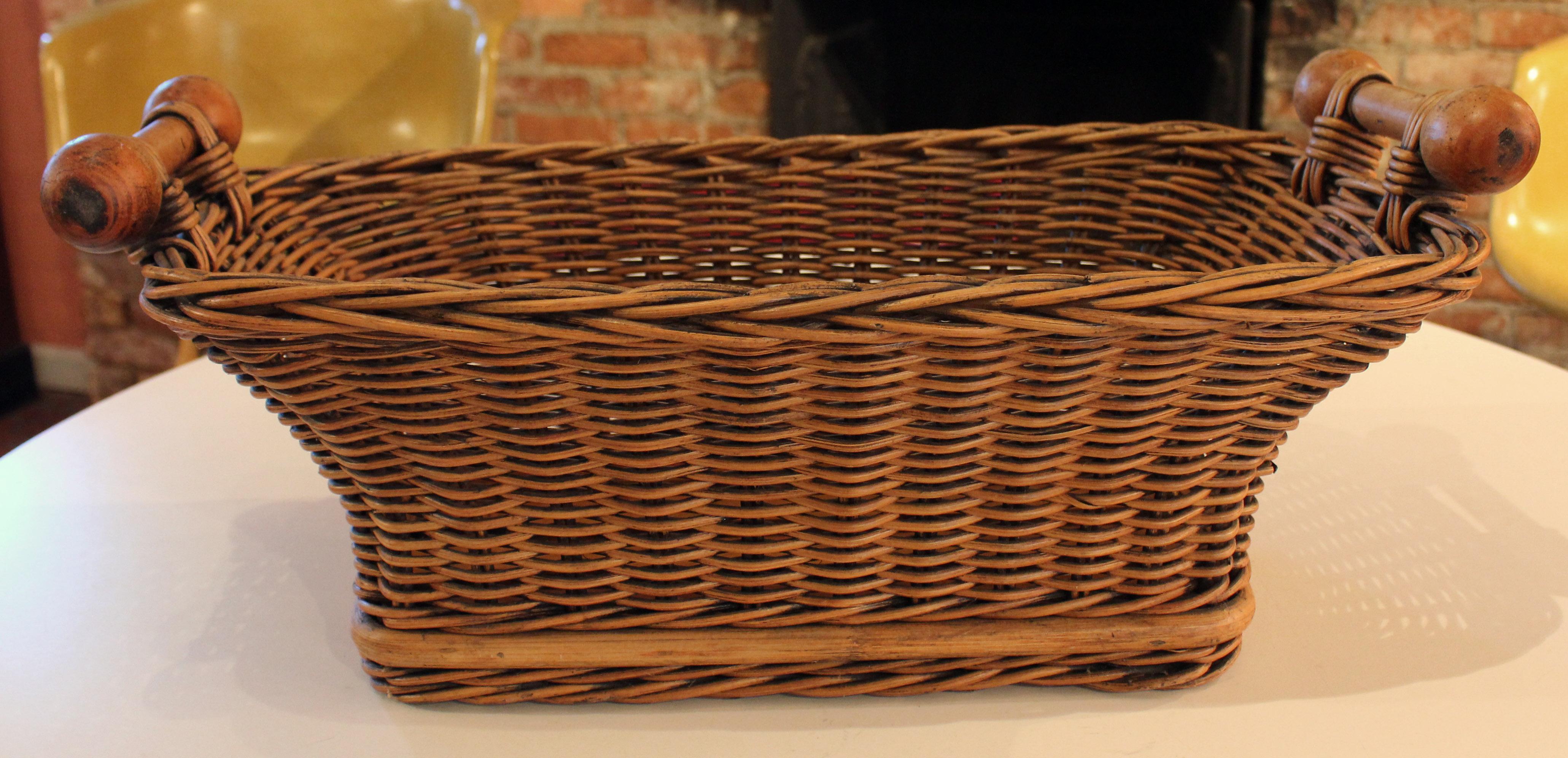 Early-mid 20th century boulangerie shop basket, French. Wicker with turned fruitwood handles & lattice bottom, for selling bread & rolls, etc. Separation in wooden bottom edge due to shrinkage, but stable & usable. Ideal for many purposes including