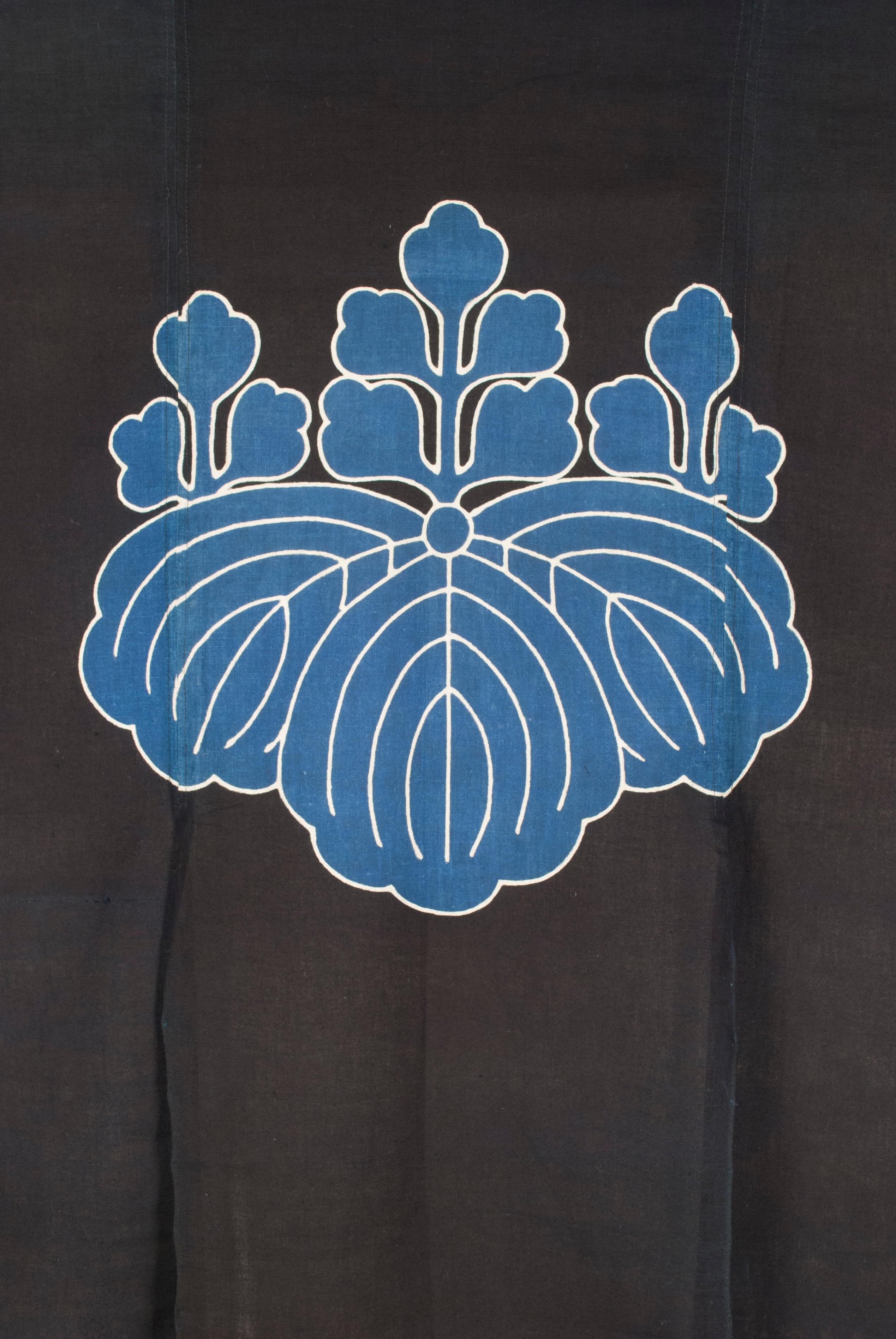 Early-mid 20th century Japanese Indigo-dyed door hanging / noren.

A Japanese three-panel door hanging depicting three rabbits frolicking above the waves, with a crest (mon) in lighter indigo centered above.










