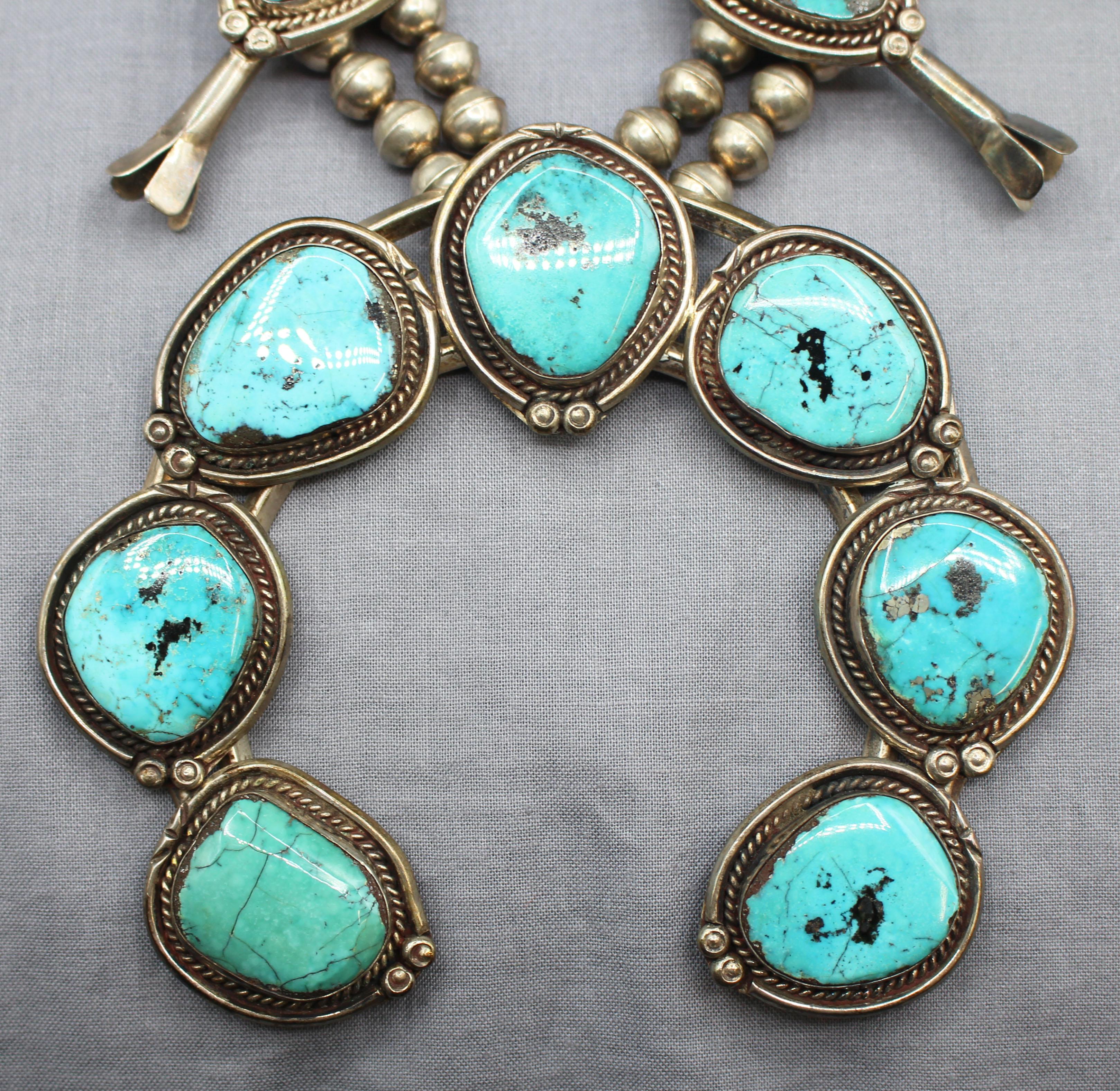 Navajo turquoise & sterling silver squash blossom necklace, early-mid 20th century. A massive & impressive piece using superb Morenci turquoise stones with grand scale najo derived from Spanish bridles, in turn influenced by the Moors of North
