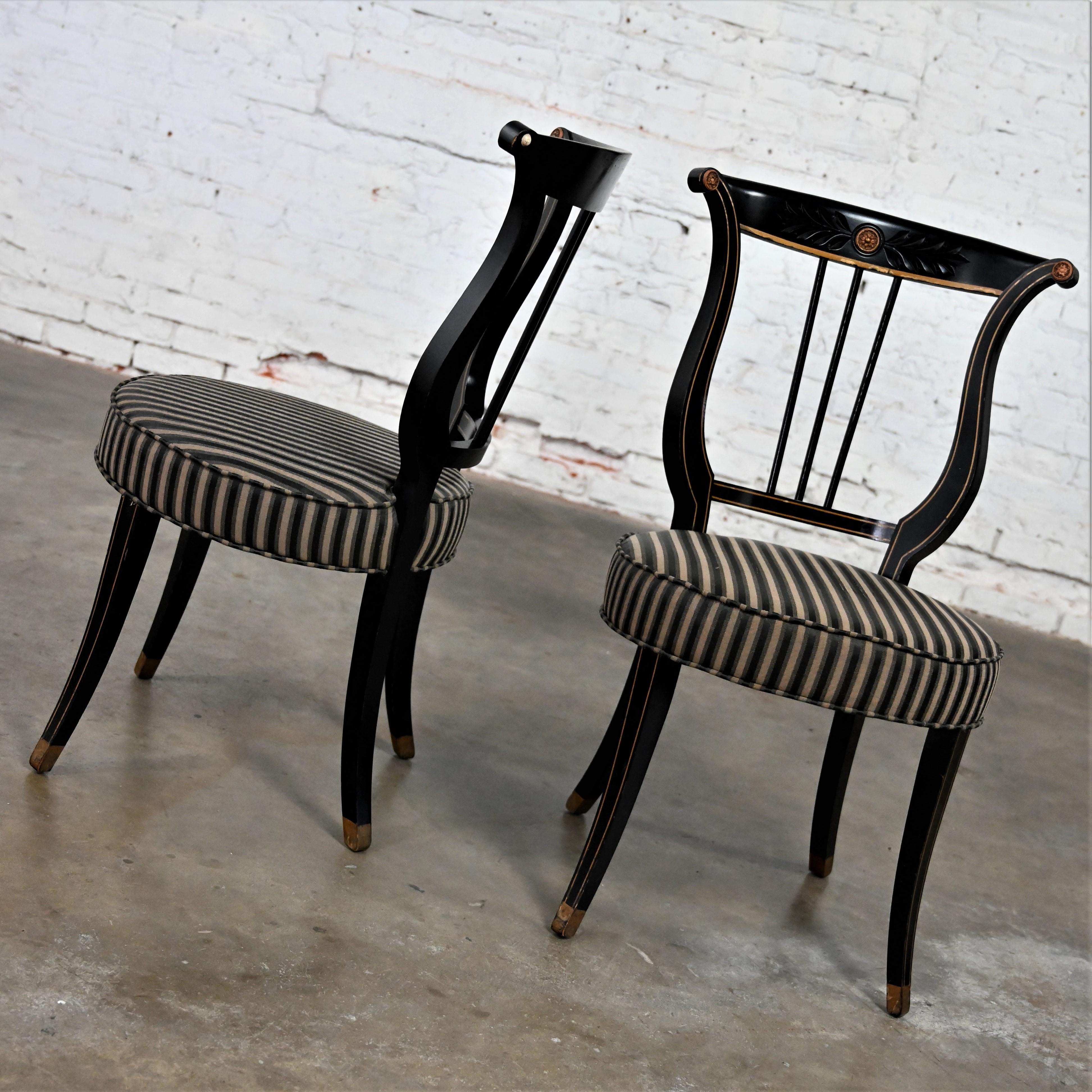 Lovely Early to Mid-20th Century Neoclassical black & gold painted lyre back accent or occasional chairs with round seats & black, beige, and gray striped fabric, a pair. Beautiful condition, keeping in mind that these are vintage and not new so