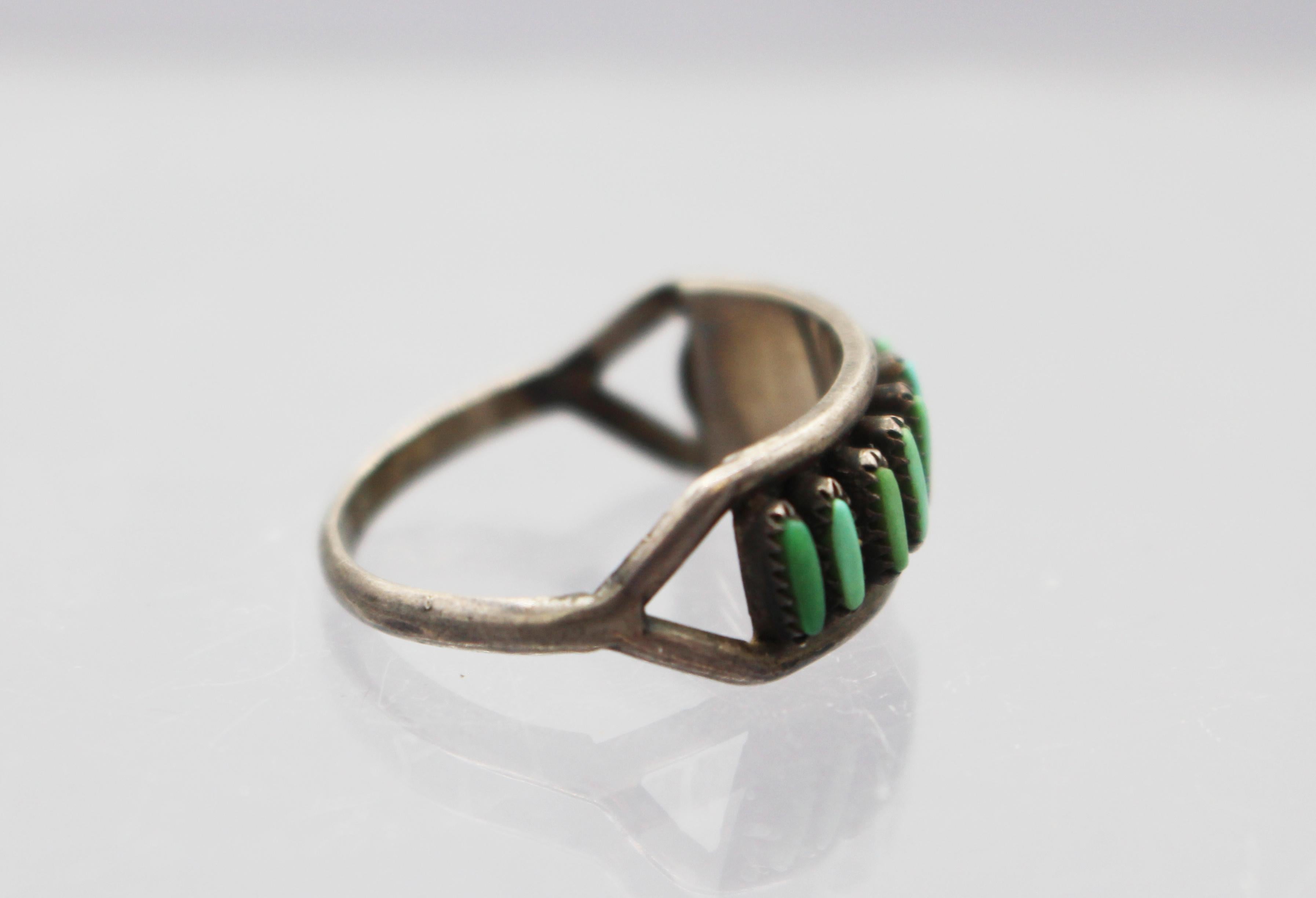 Early-mid 20th century Zuni turquoise & sterling ring. Elegant, needlepoint work - rare & desirable. Size 6 1/2.

We are a family business that has been a major source for the selective buyer for over 90 years. We are one the finest antiques shop in