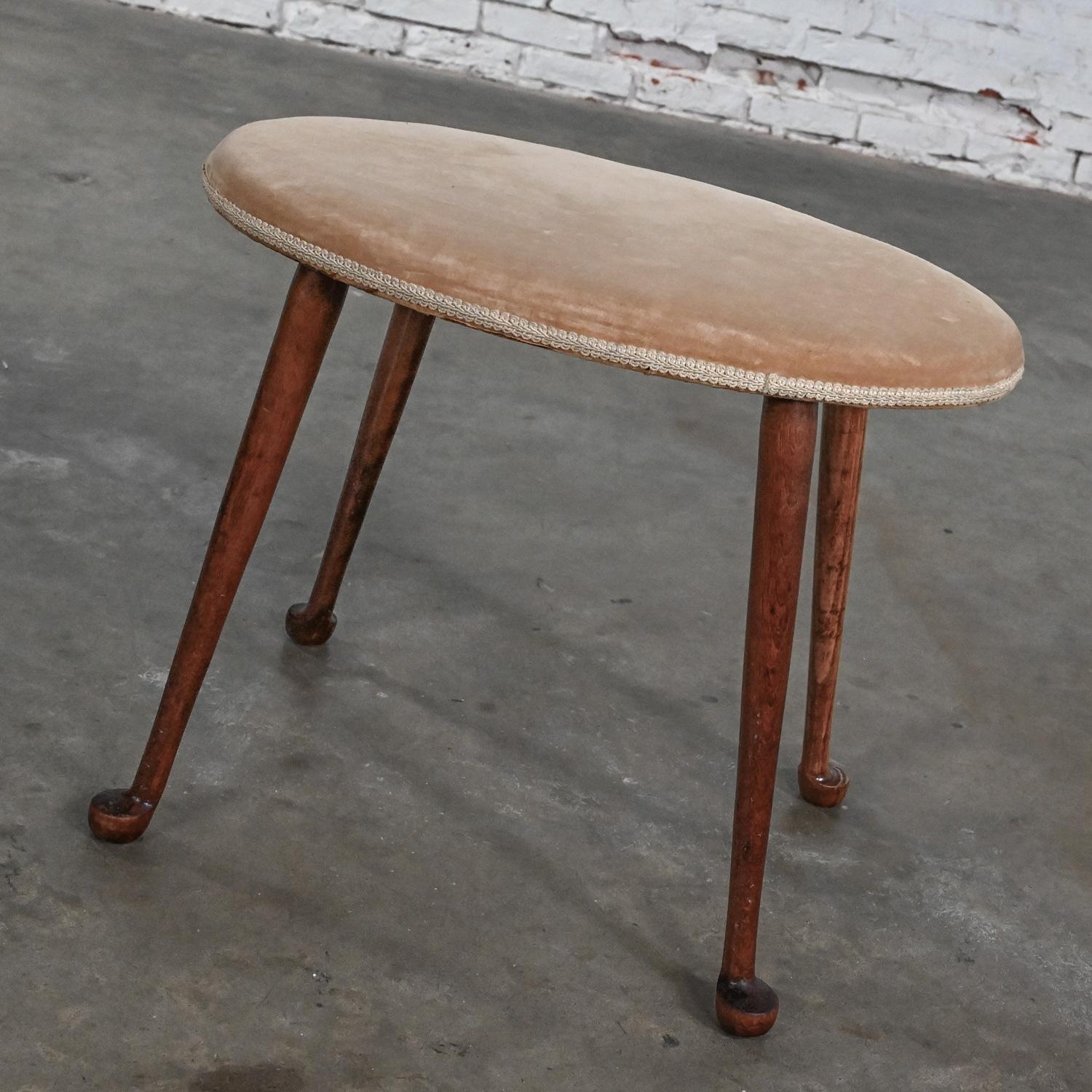 Handsome vintage Colonial style Conant Ball low stool with oval seat with vintage destressed tan velvet upholstery and maple splayed legs with ball feet. Beautiful condition, keeping in mind that this is vintage and not new so will have signs of use
