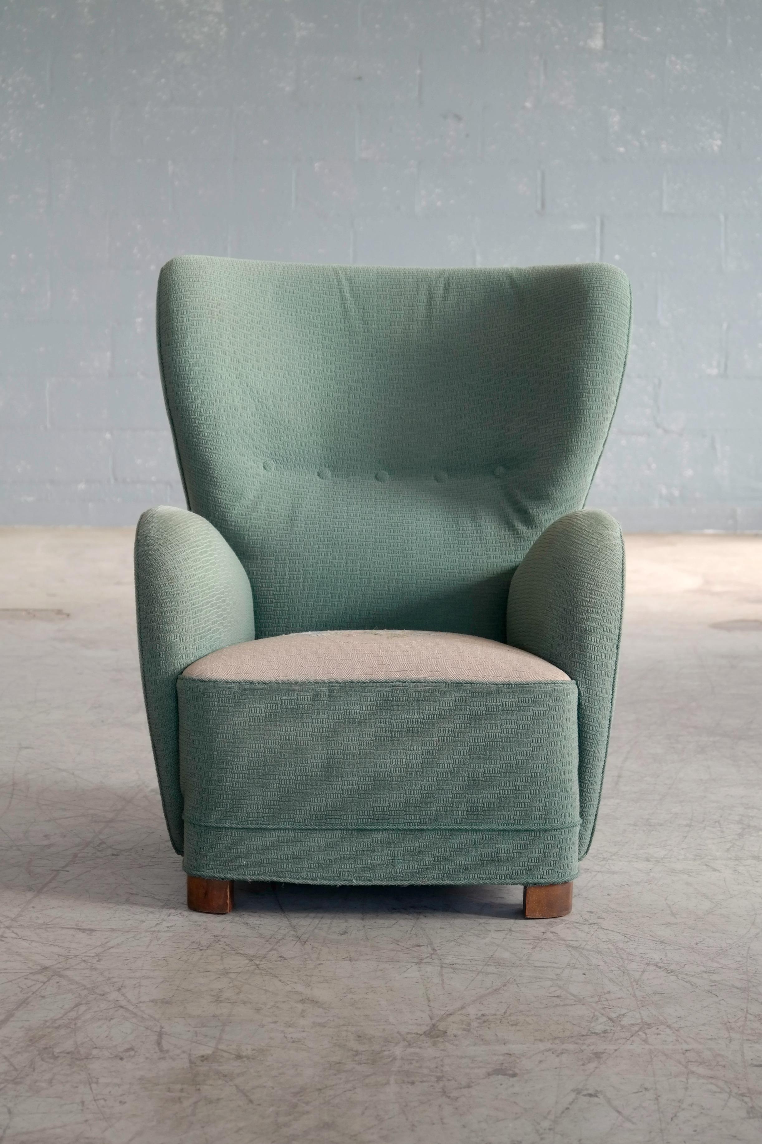 Fantastic Danish 1940s large high back armchair still covered in its original two-tone wool fabric. Great statement piece for any room. The chair is much in the style of Viggo Boesen and Flemming Lasssen especially with the rounded armrests the