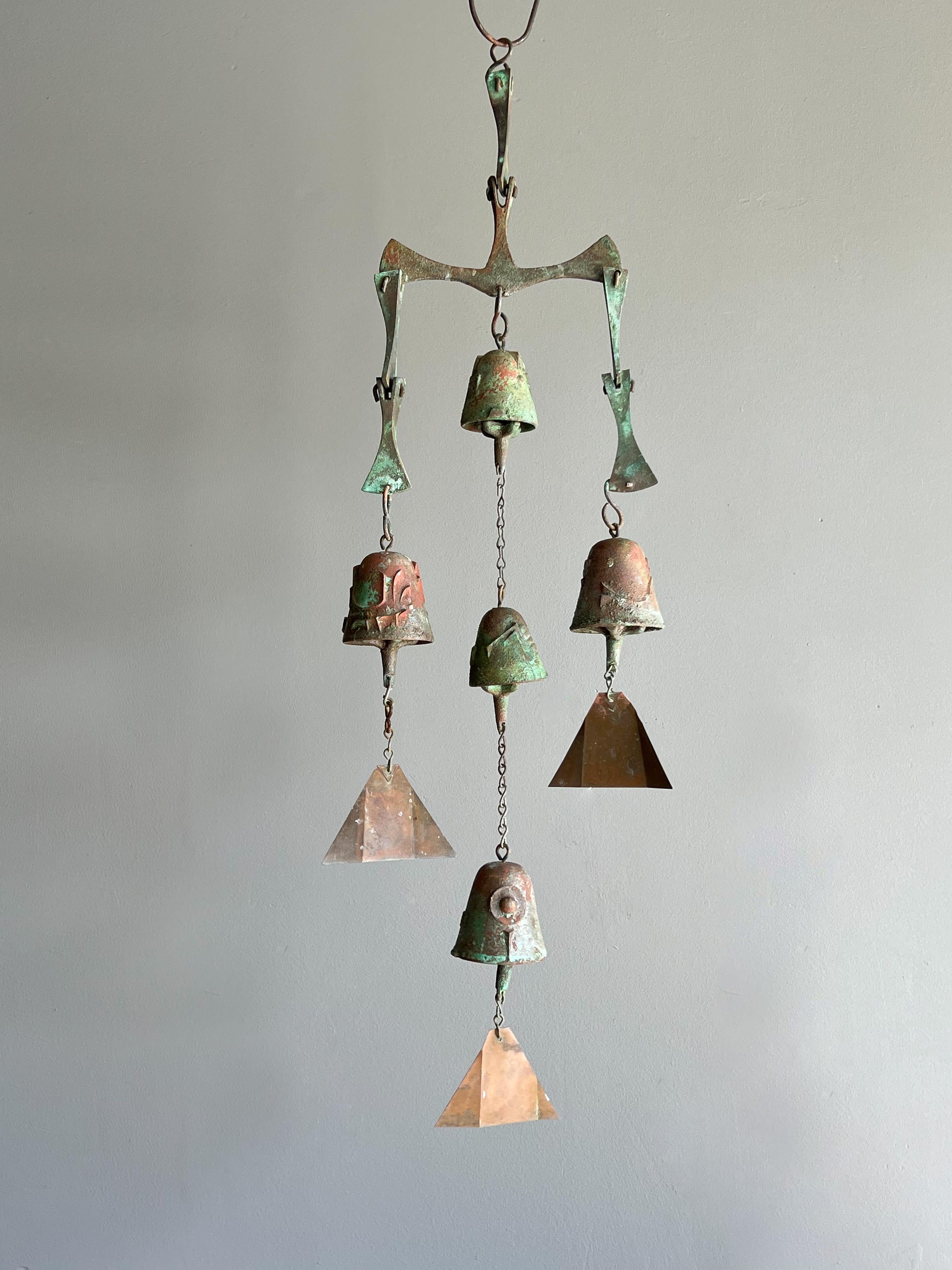 Beautiful and early wind chime / bell designed by architect Paolo Soleri for Arcosanti. This example features three arms and five bells in total. 

Constructed of casted bronze elements showing a lovely environmental and natural age verdigris