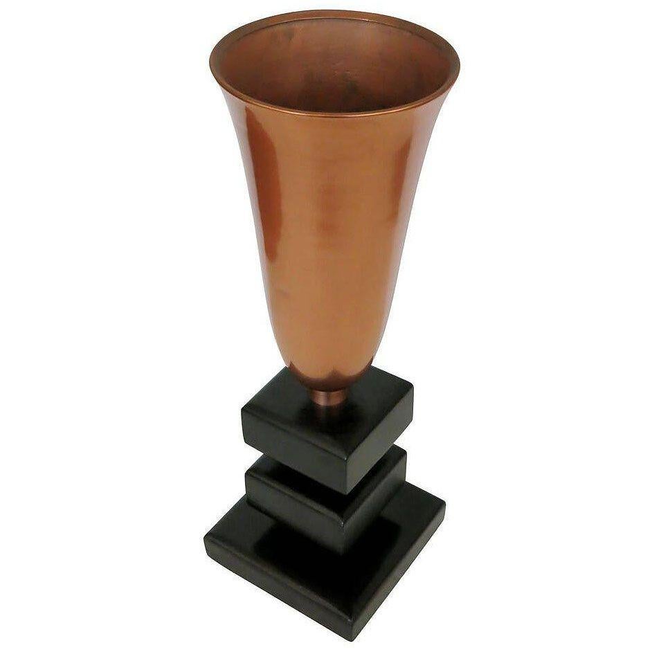 Early Mid-century copper torchiere table lamp, featuring a slender copper torchiere lampshade and stacked base made of lacquered wood steps with decorative copper links.

This lamp is a great example of early Mid-Century design leaving its Art Deco
