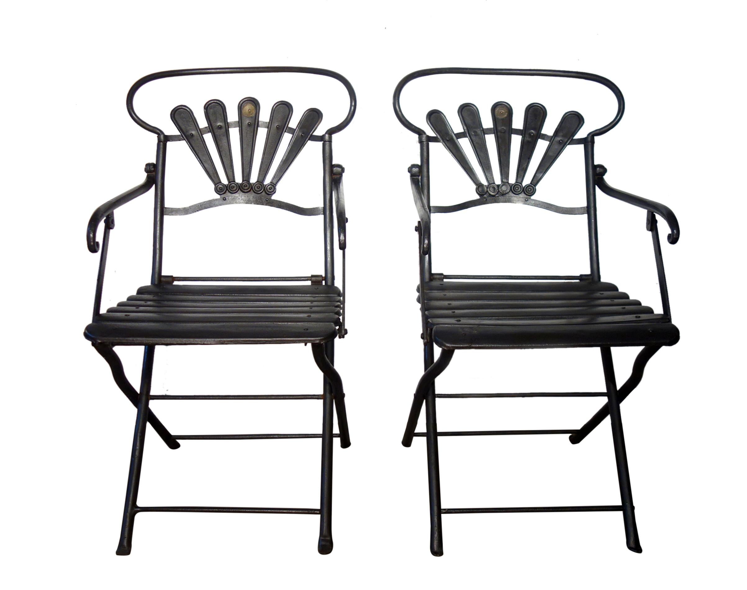Comfortable pair of Carlo Crespi wrought iron folding armchairs, handcrafted in the Village of Parabiago, Milan Italy.

The style details are superb: the curved chair back orb, the fanned back support with Carlo Crespi medallion, the sculpted &