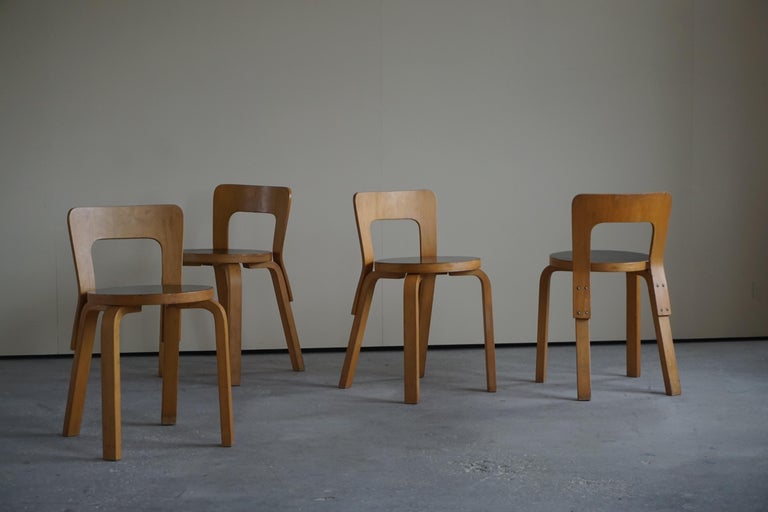 Finnish designer Alvar Aalto Model 65, set of 4 dining chairs by Artek Finland circa 1950s. Laminated birch chairs with moulded plywood back rests screwed to rear legs. Alvar Aalto designed these chairs in 1935 with functionality, simplicity, and