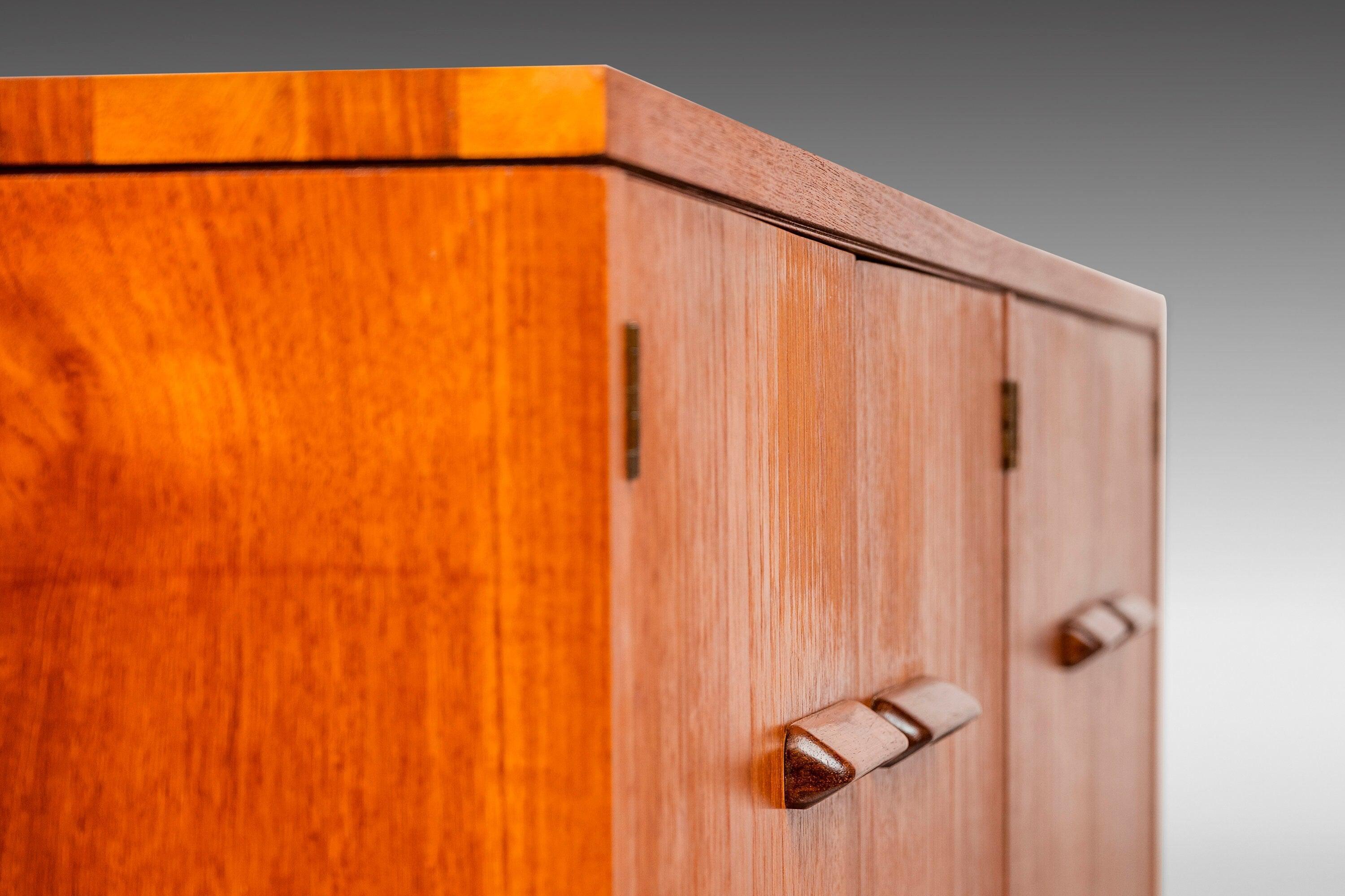 This extraordinary sideboard by Lane Furniture (Serial # 758250) is as rare as it is aesthetically captivating. The details of this piece are both subtle and eye-catching with an exquisite dovetail joint running along the top edges as well as the