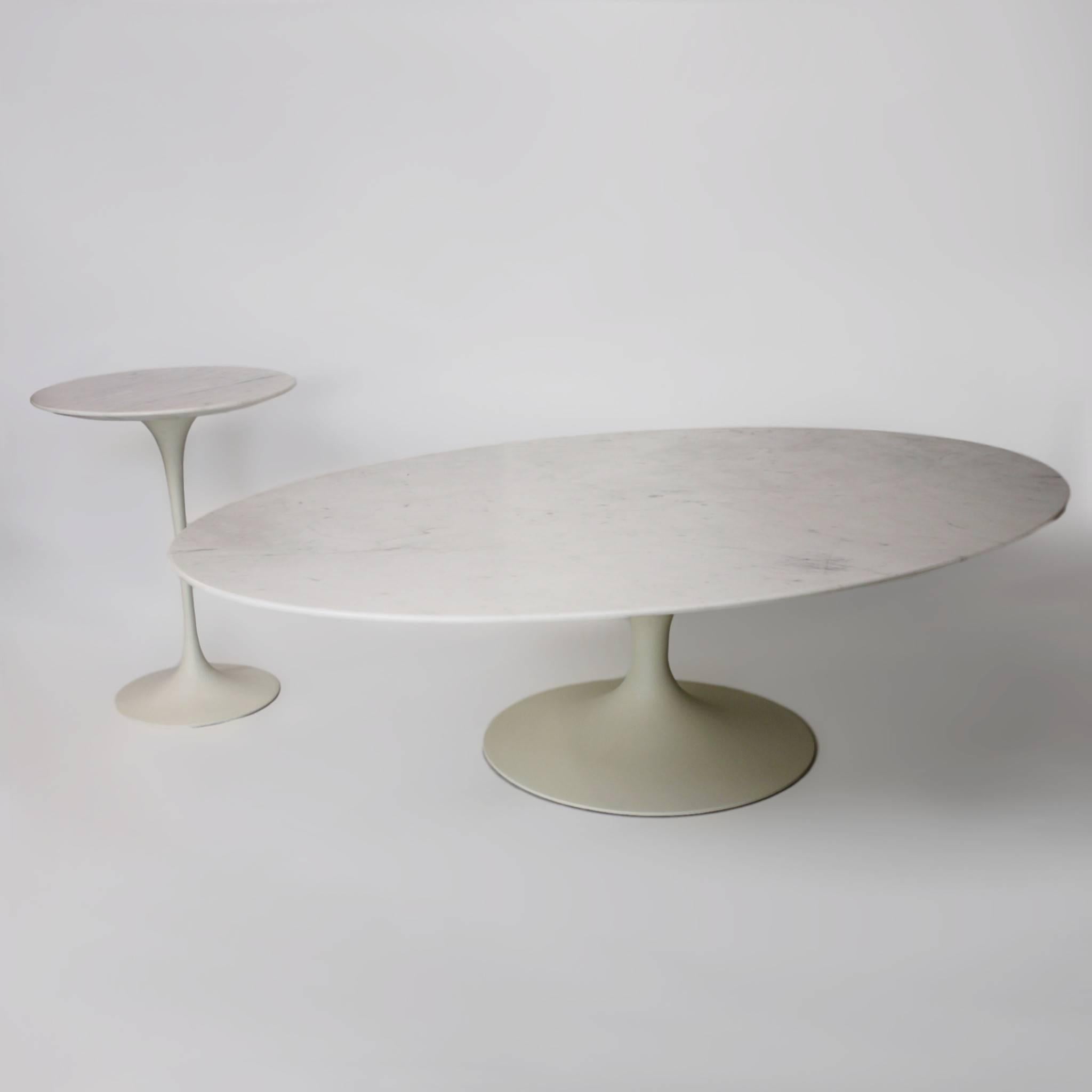 This is a spectacular, matching pair of tables by the renowned designer Eero Saarinen for Knoll. These tables represent the first-run of tables produced between 1957 and 1961. Tables feature the early cast-iron bases (later bases were aluminium) and