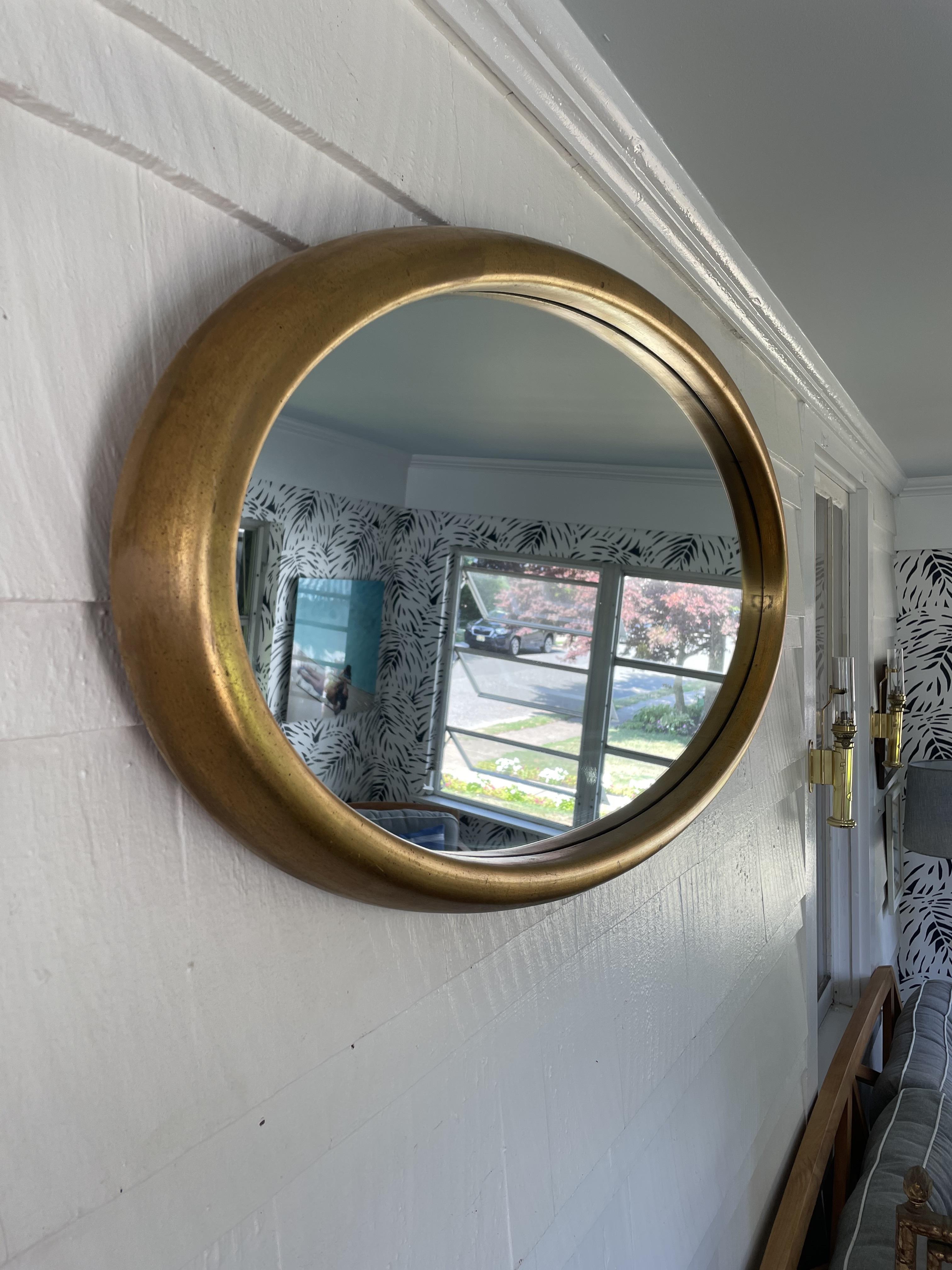 Big pop in this large oval mirror from the 1950's-60's. Deep bordered frame in gold gilt finish.