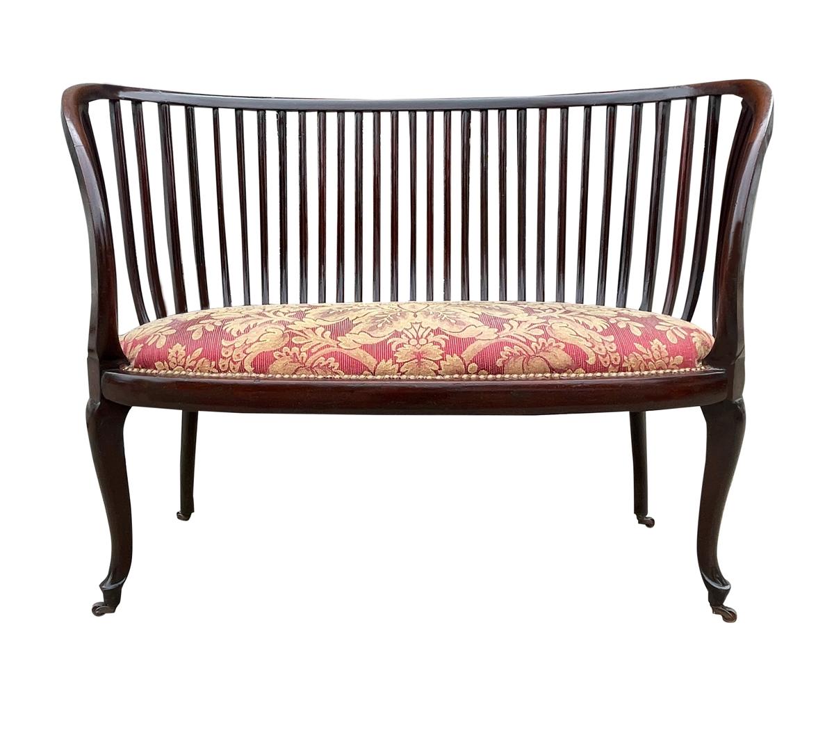 An incredible piece of artistry. This spindle back bench dates back to the 1940's and is made out of mahogany. A great mix of modern and traditional lines.