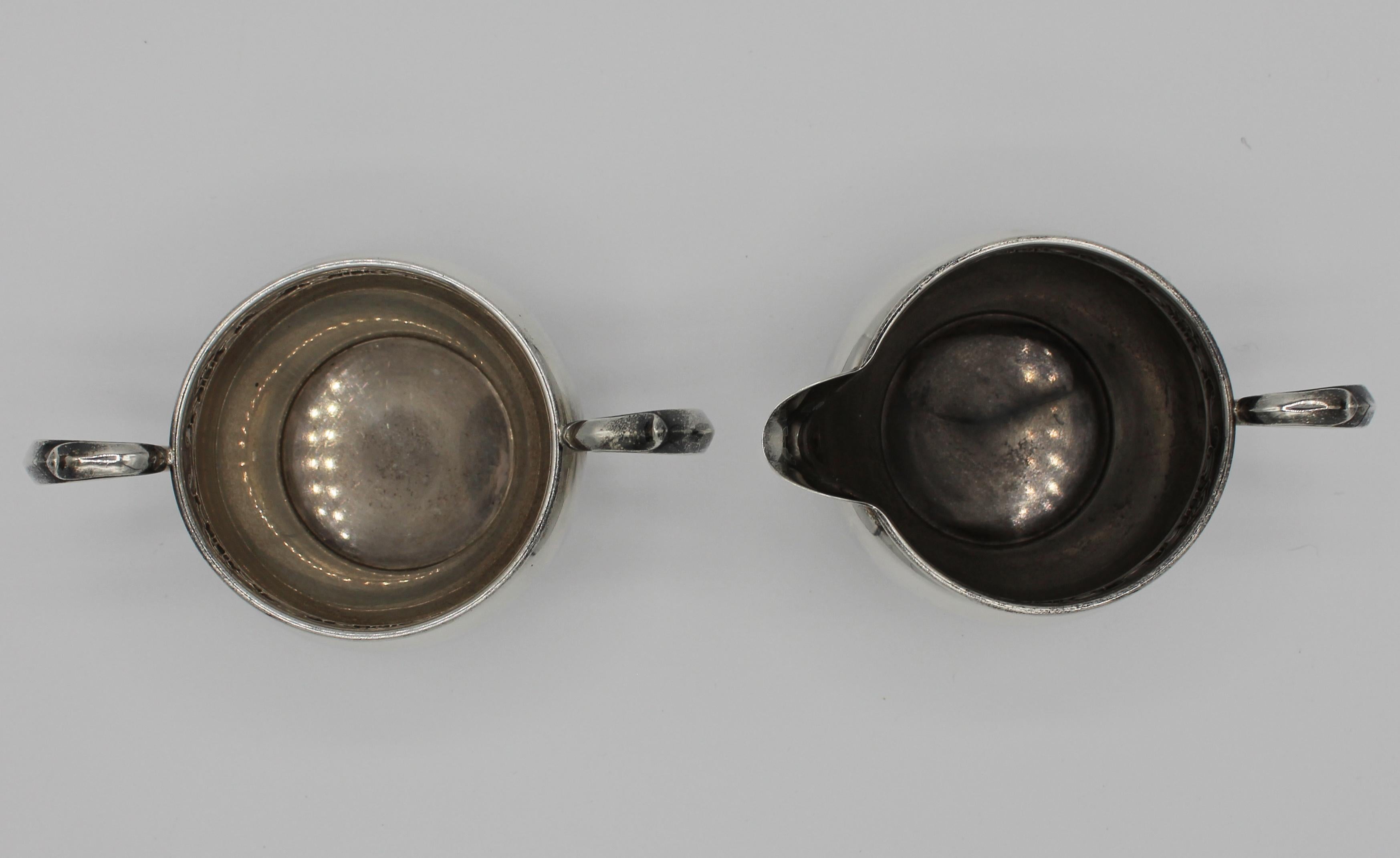 Early-mid 20th century sterling cream and sugar, by Gorham, Strasbourg pattern, c-scroll and cartouche border. Creamer marked 1133, sugar marked 1132. 5.95 troy oz. 5 5/8