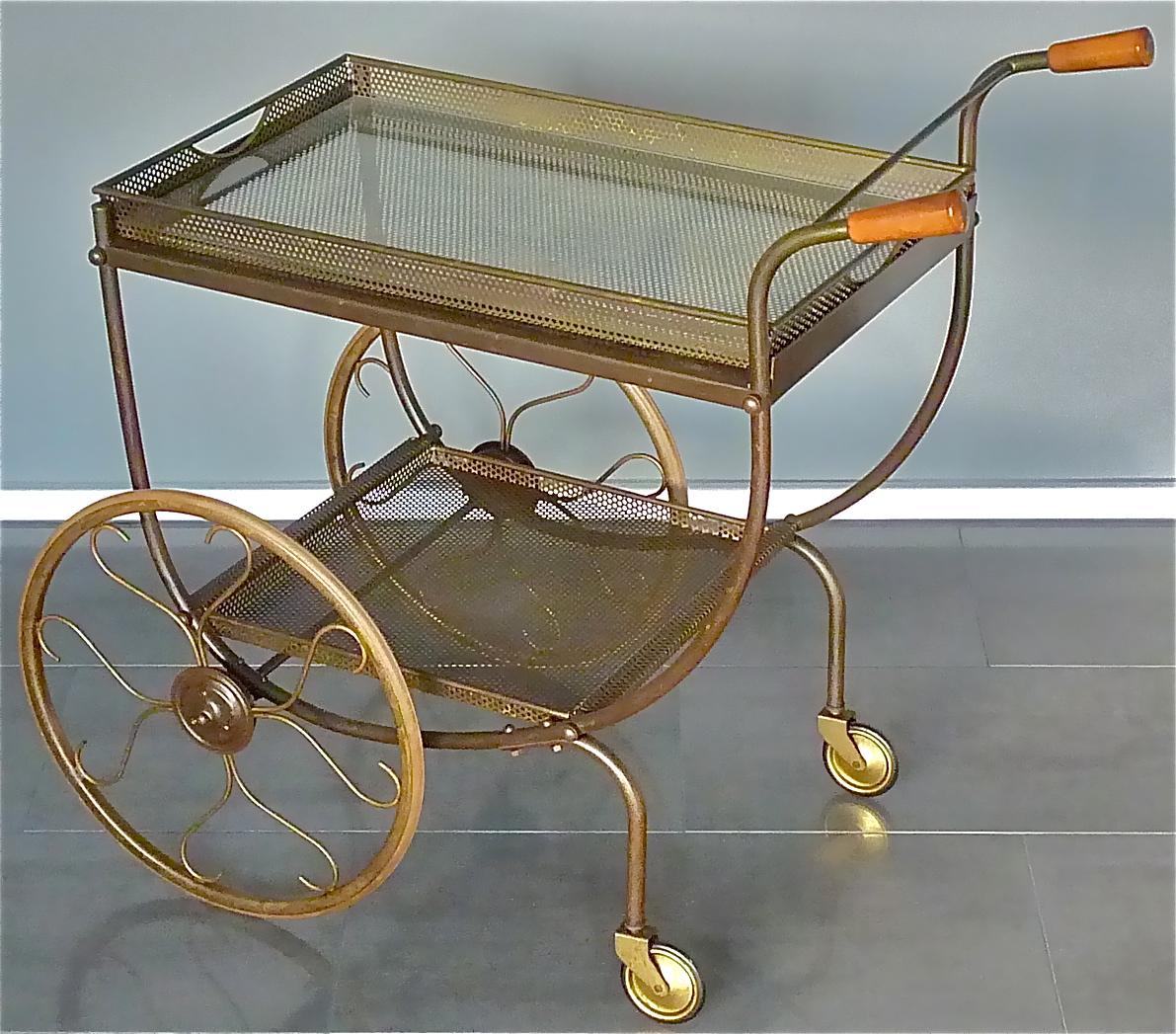 Early midcentury and beautiful patinated brass bar cart or drinks trolley designed by Josef Frank and executed by Svenskt Tenn, Sweden around 1940s to 1950s. The fantastic Scandinavian bar cart which is made of tubular patinated brass has two wood