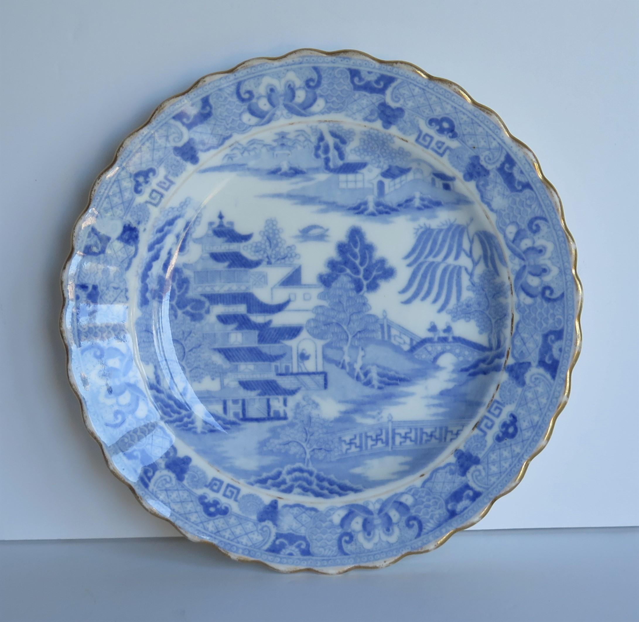 This is porcelain blue and white, hand gilded desert dish or plate made by Miles Mason (Mason's), Staffordshire Potteries, England around the turn of the 18th century, circa 1800.

The dish is well potted on a low foot with a scalloped wavy